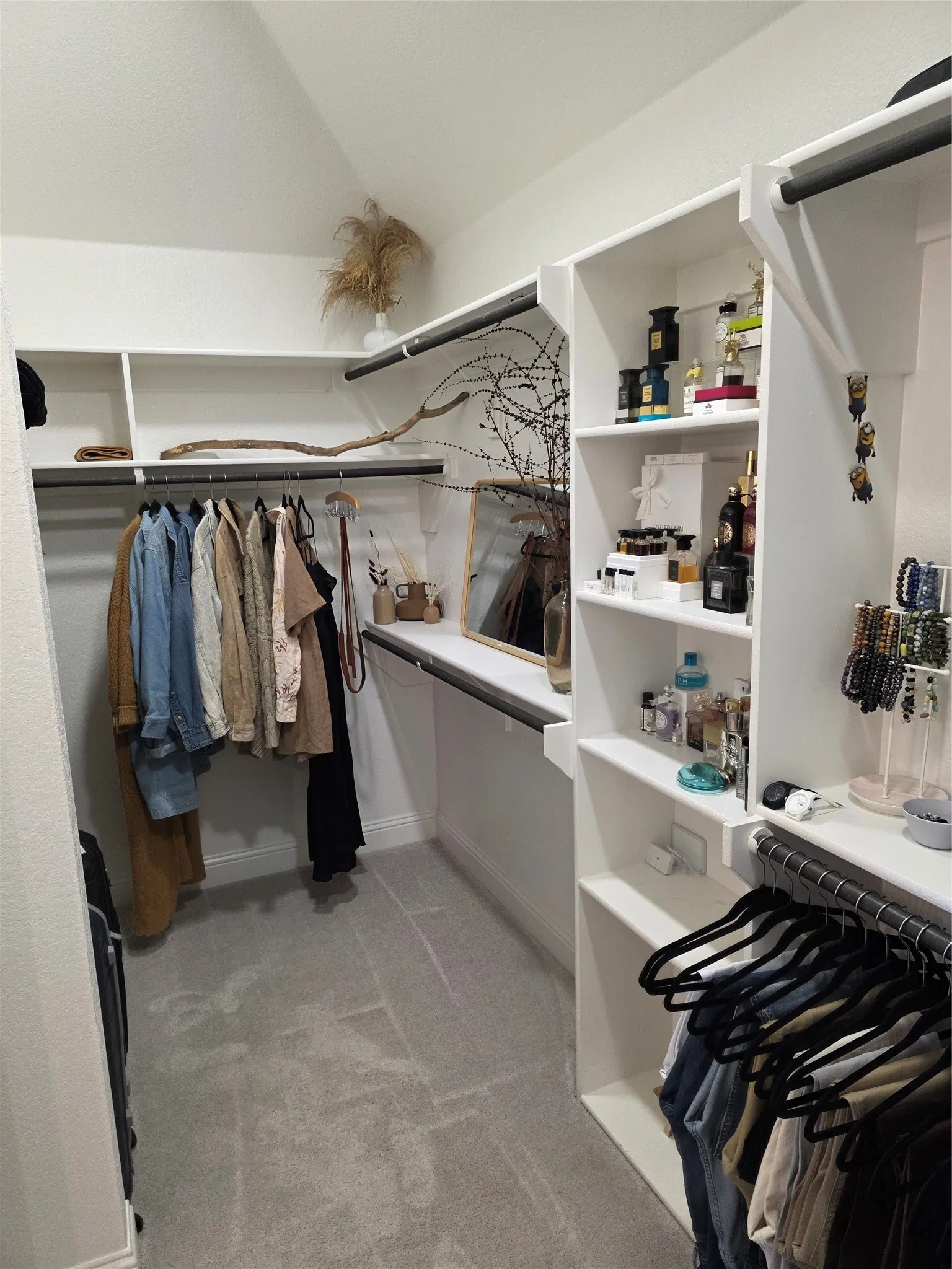 Spacious closet featuring light carpet and lofted ceiling