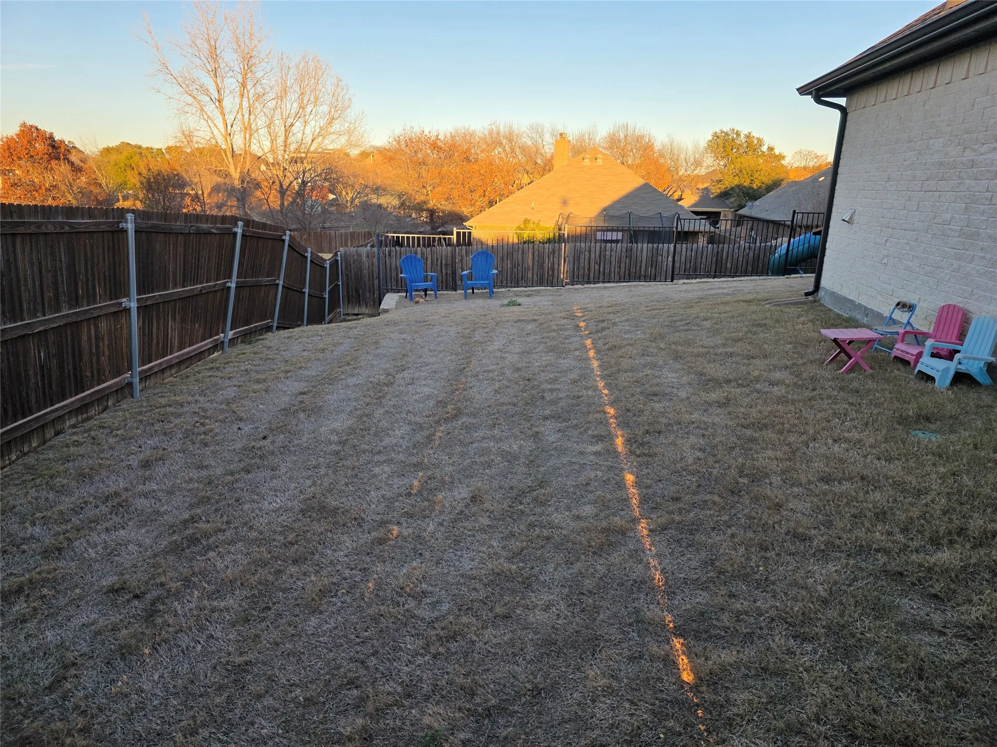 View of fenced backyard