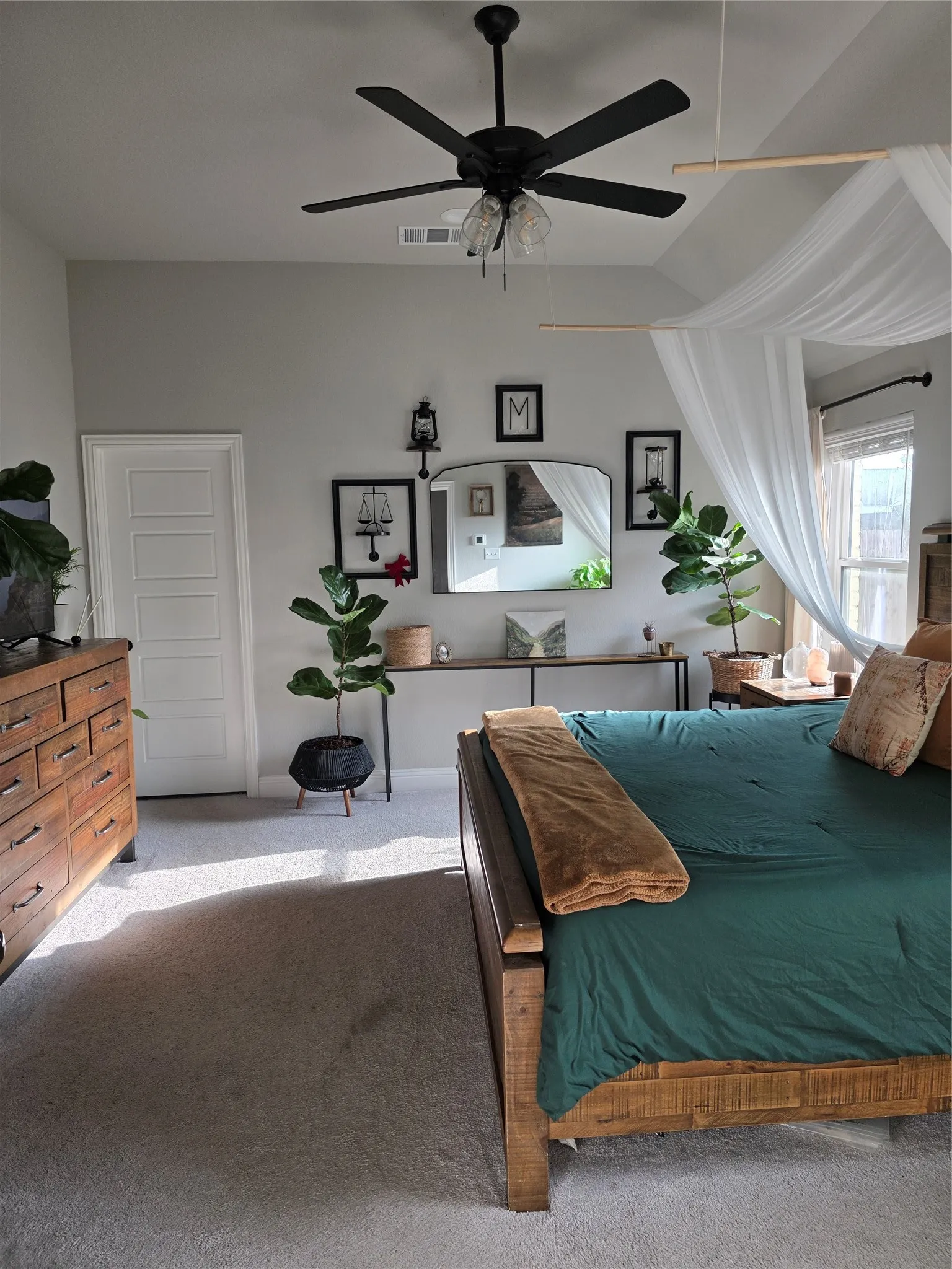 Carpeted bedroom featuring a ceiling fan and baseboards