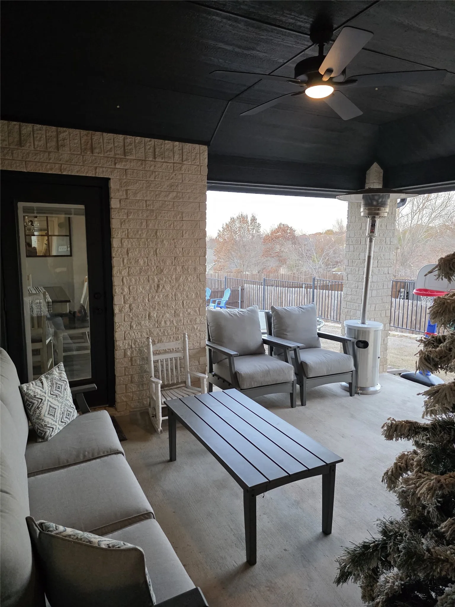 View of patio with an outdoor hangout area and a ceiling fan