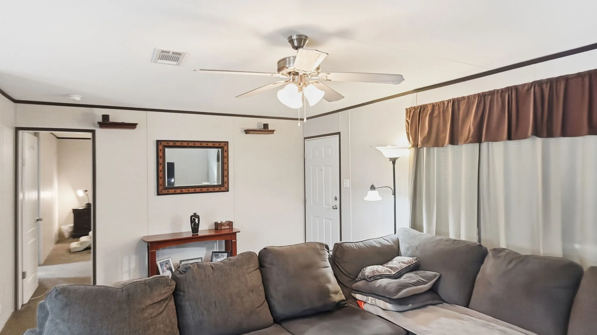 Living room with primary bedroom to left side
