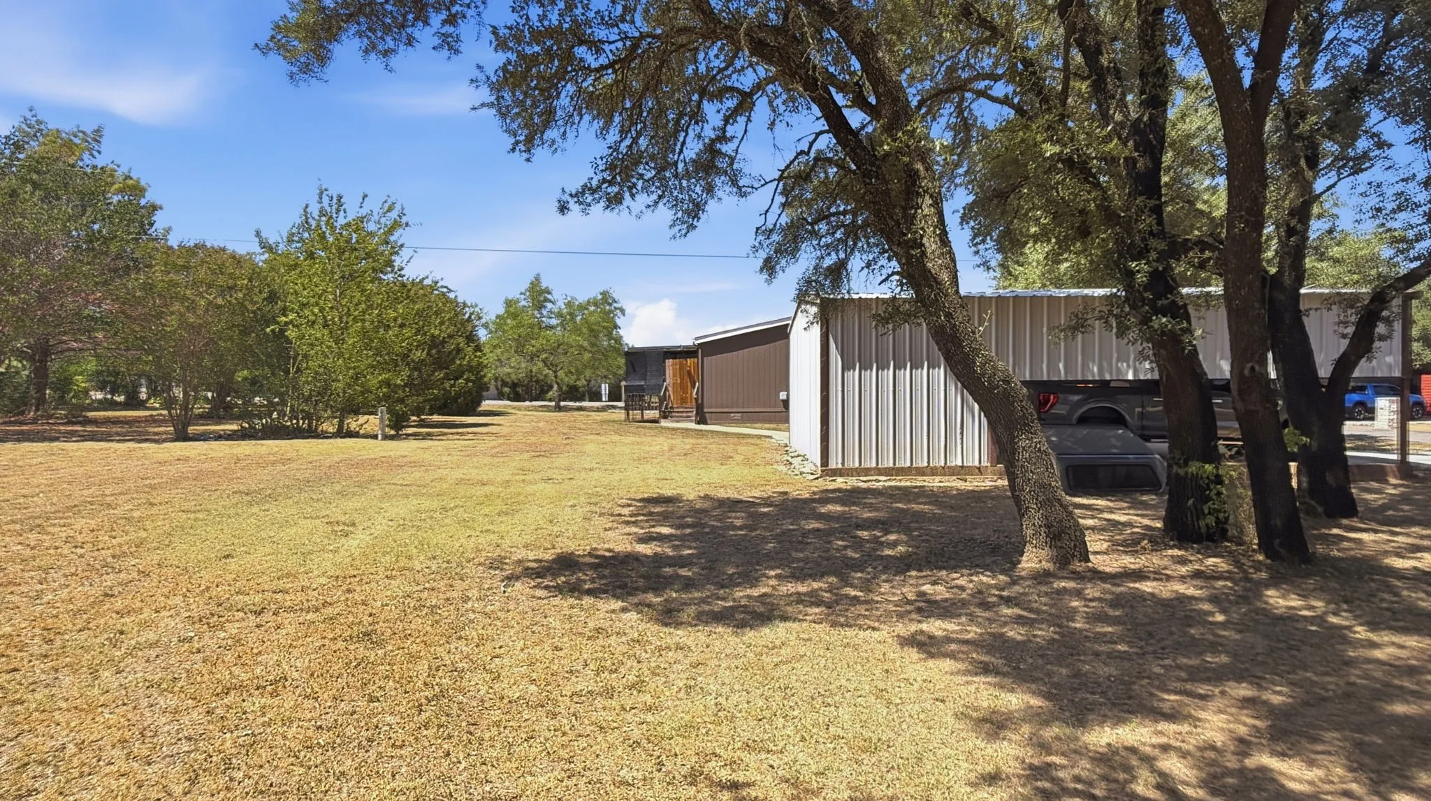 Backyard and side view of detached carport