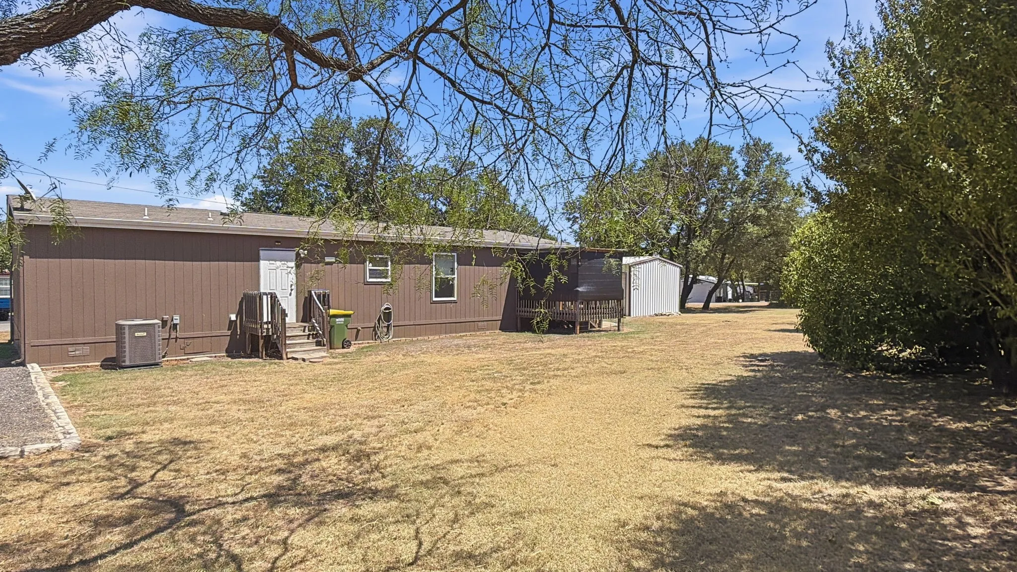 Back of home with covered deck