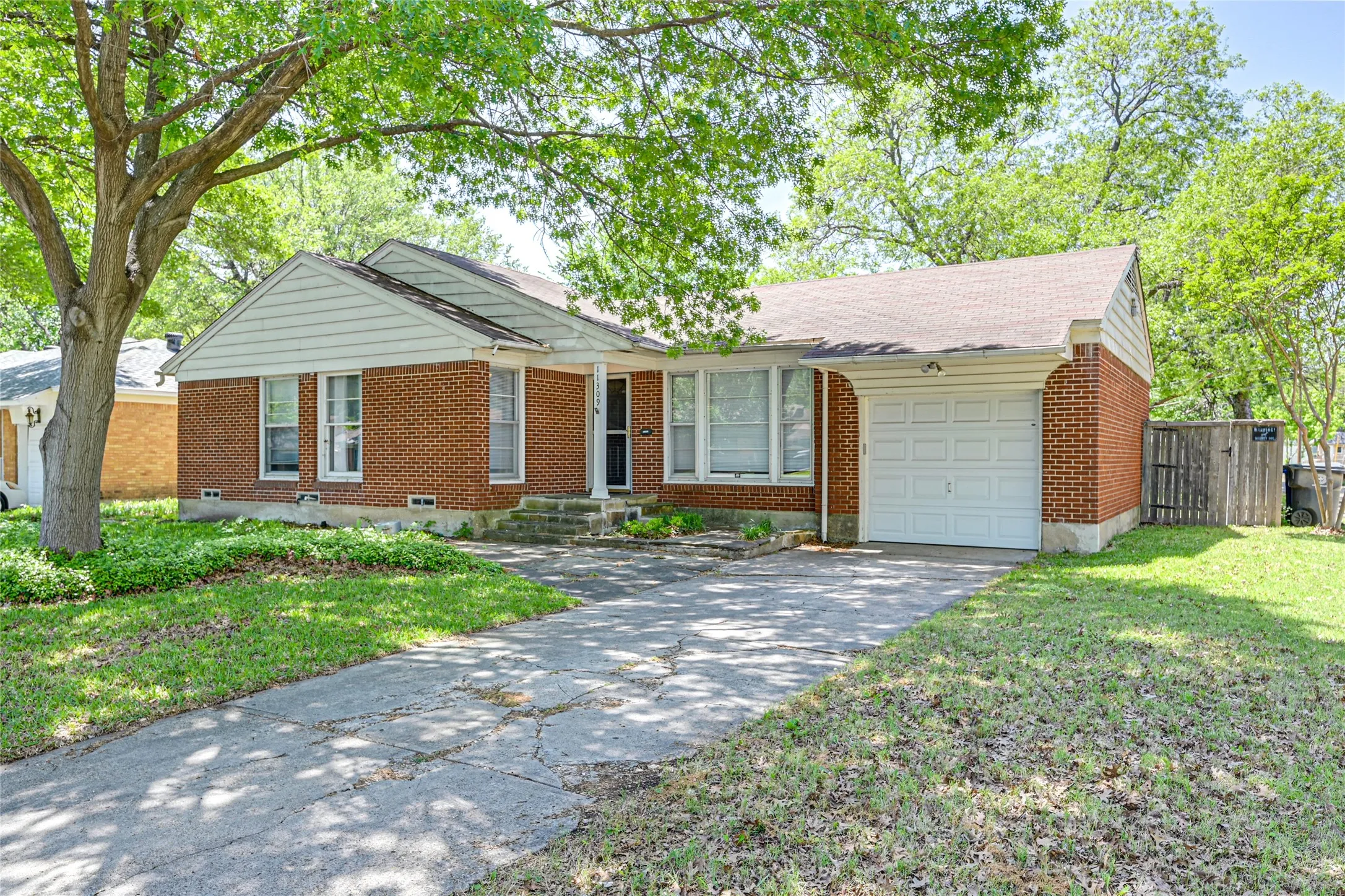 Traditional brick exterior with white siding accents and a covered front entry