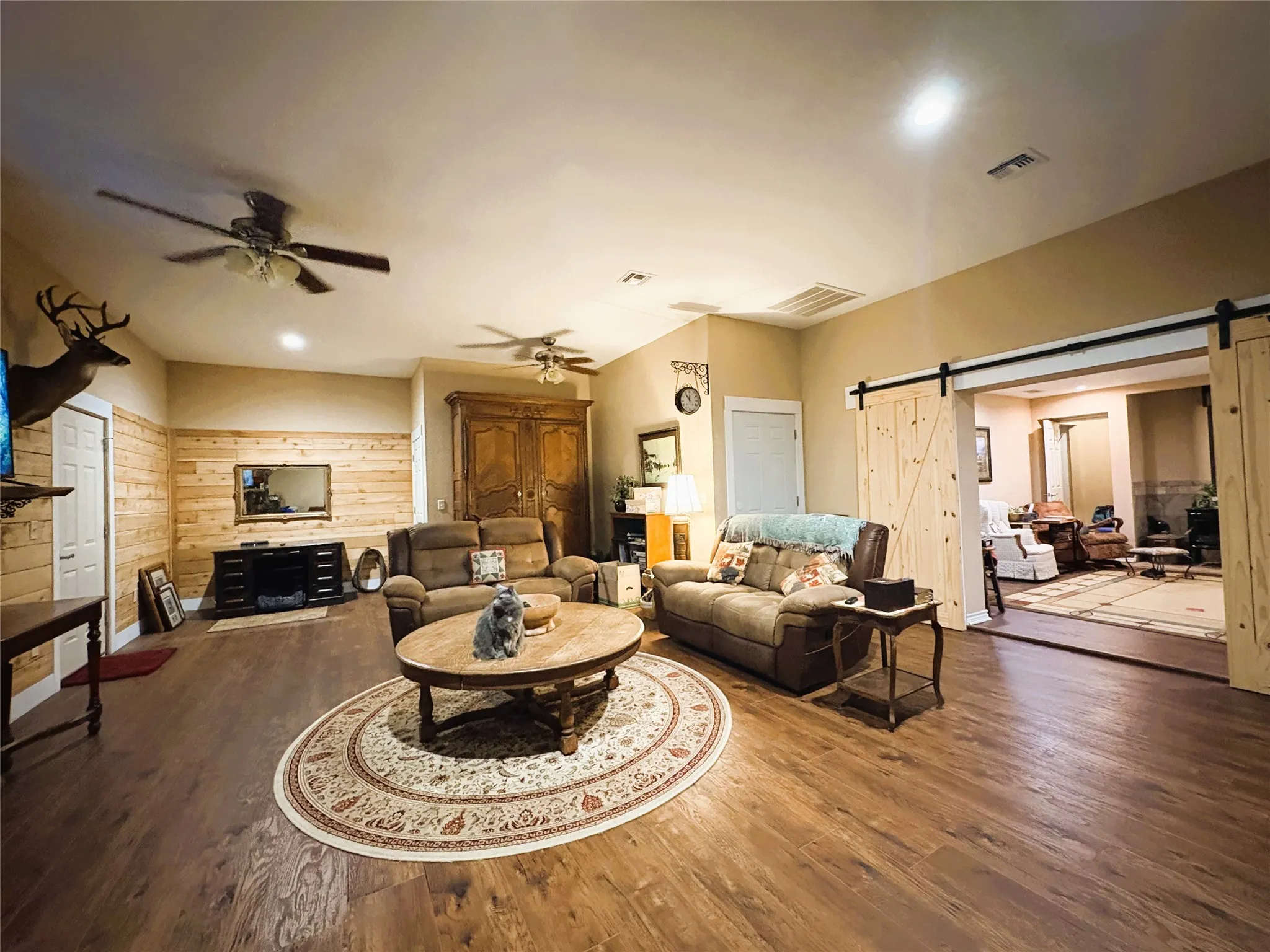Wood-finish flooring, recessed lighting, and ceiling fans