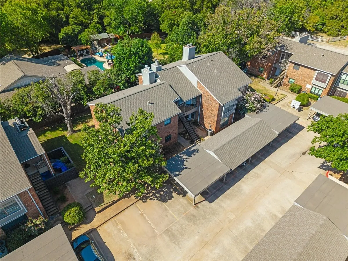 Aerial view of building 400 Pebble Way, and 161 corner. Your parking space is the end space with cover. Guest parking to left.. Note private homes behind. You'll be at the very back of The Columbine.