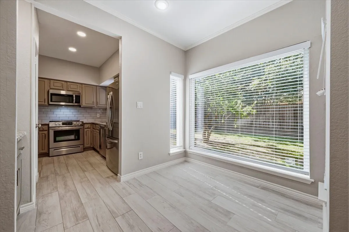 View of kitchen through the dining space. Note, the wonderful refrigerator remains!