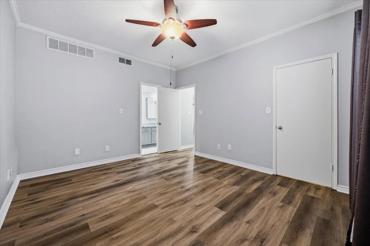 Another view of the primary bedroom. Note access to bath, and hallway.