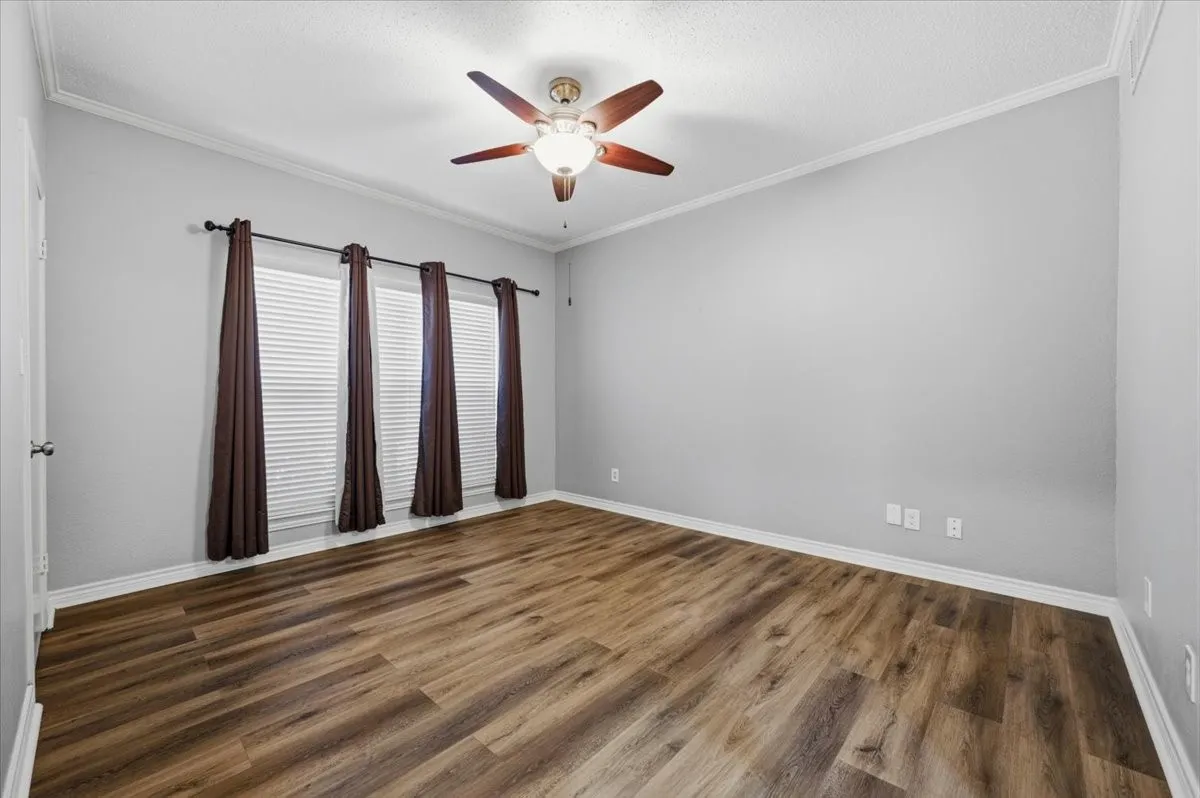 Primary bedroom with fresh flooring, paint ceiling fans, everything is ready for you!