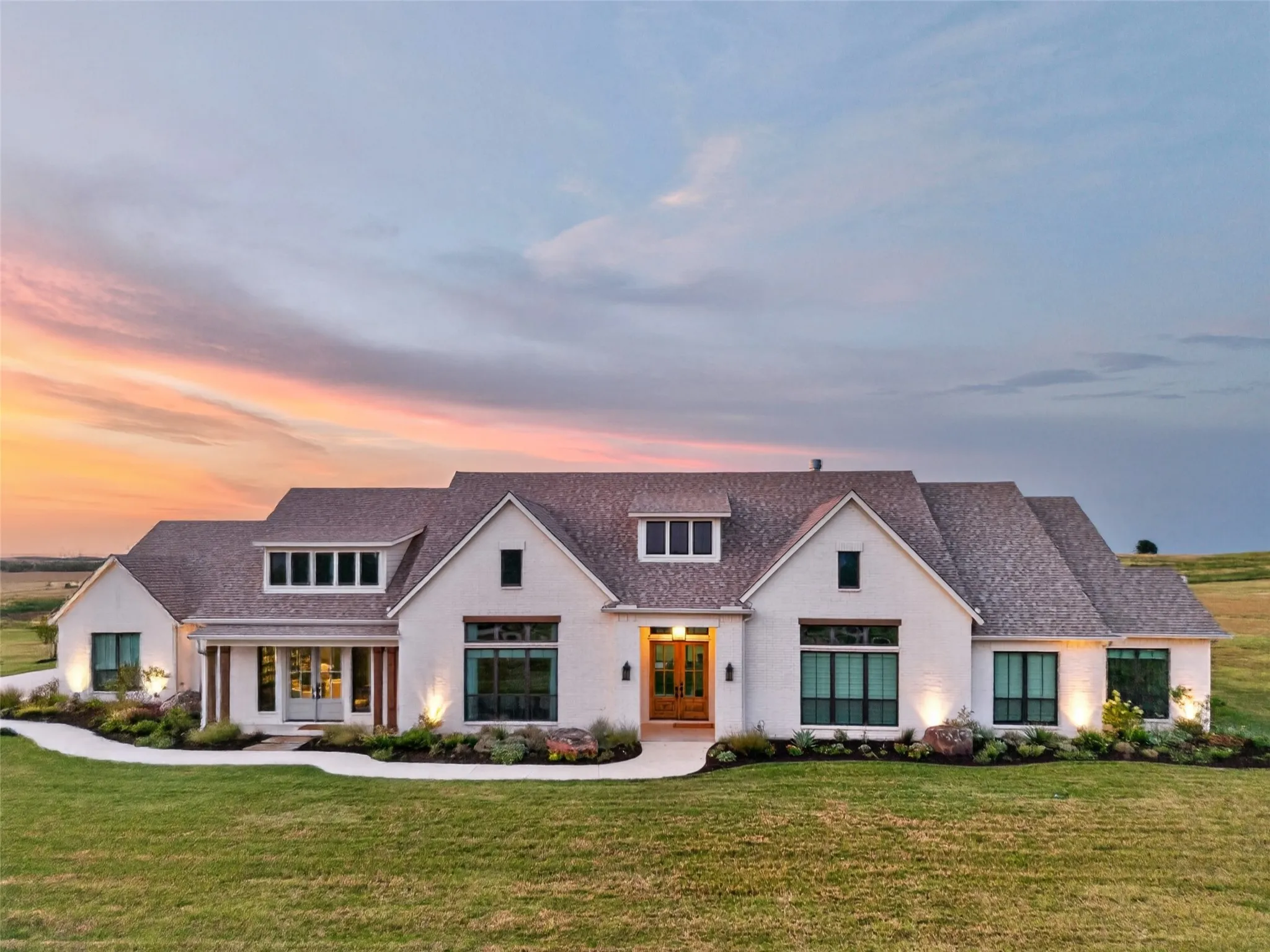 White brick exterior with a multi-gabled roof and dark-framed windows