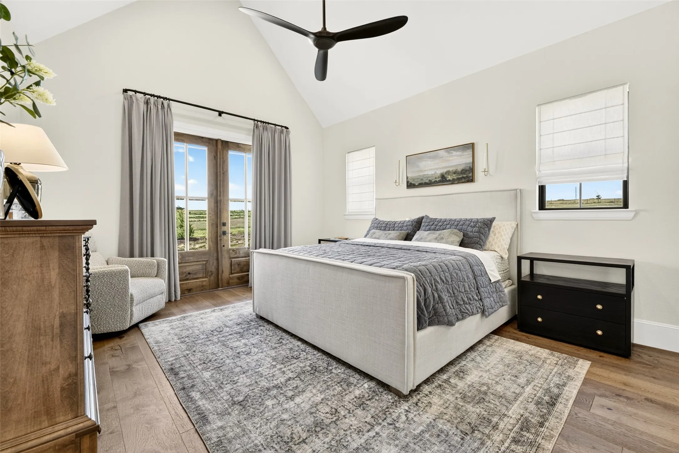 Vaulted ceiling with a ceiling fan, French doors with glass panes, wood-finish flooring, multiple windows, and recessed lighting