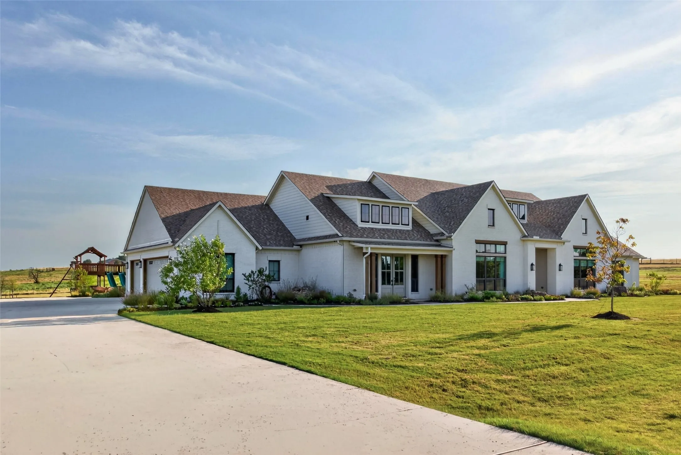 White exterior with a multi-gabled roofline and dark shingle roofing