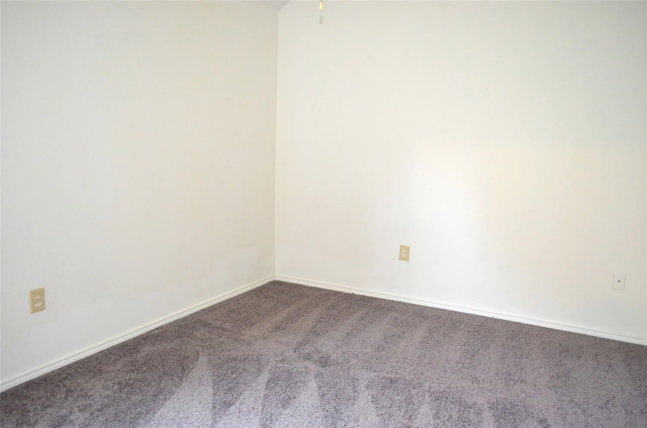 Light-colored walls with neutral carpeting