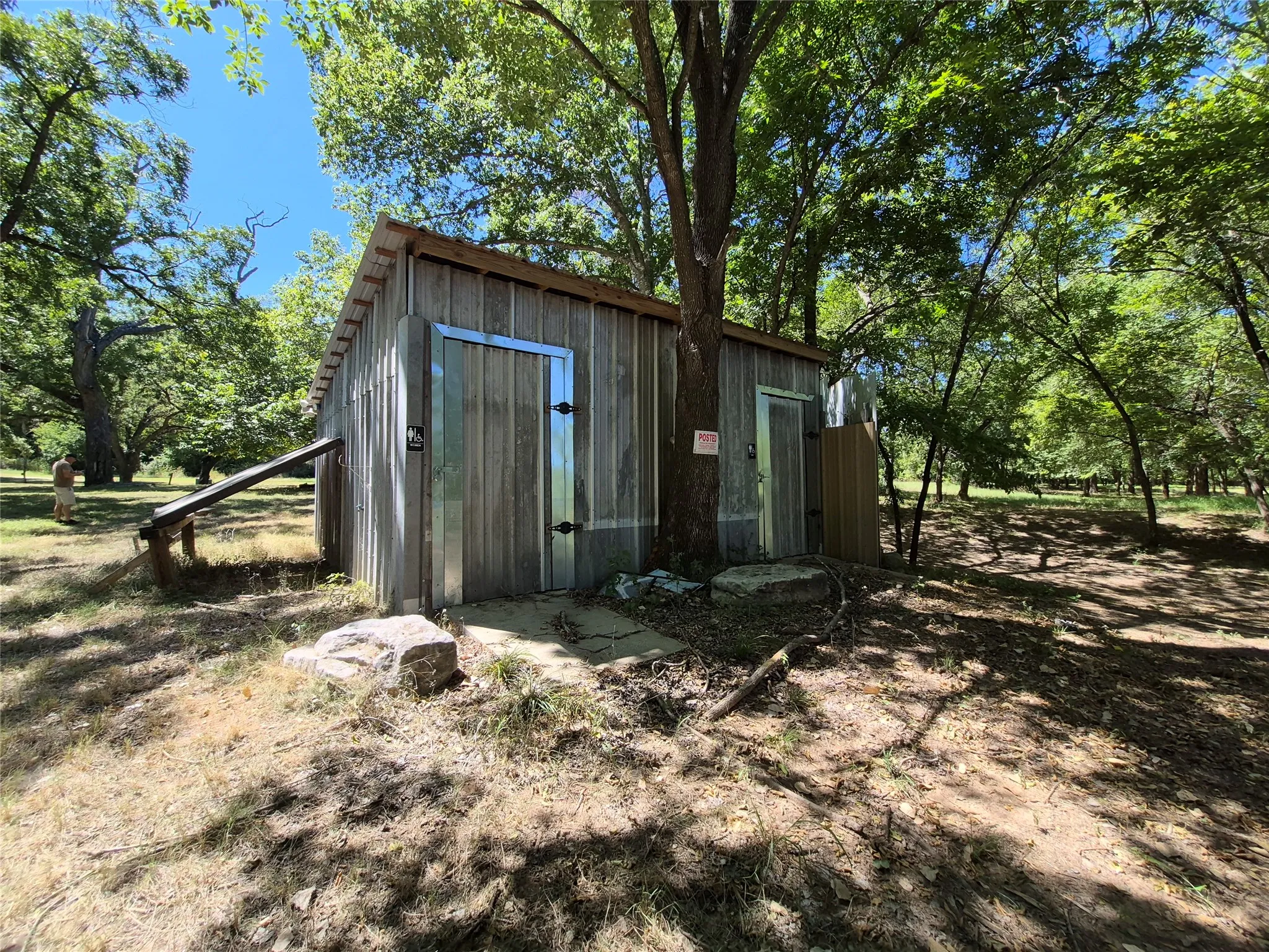 Wood-sided structure with metal doors