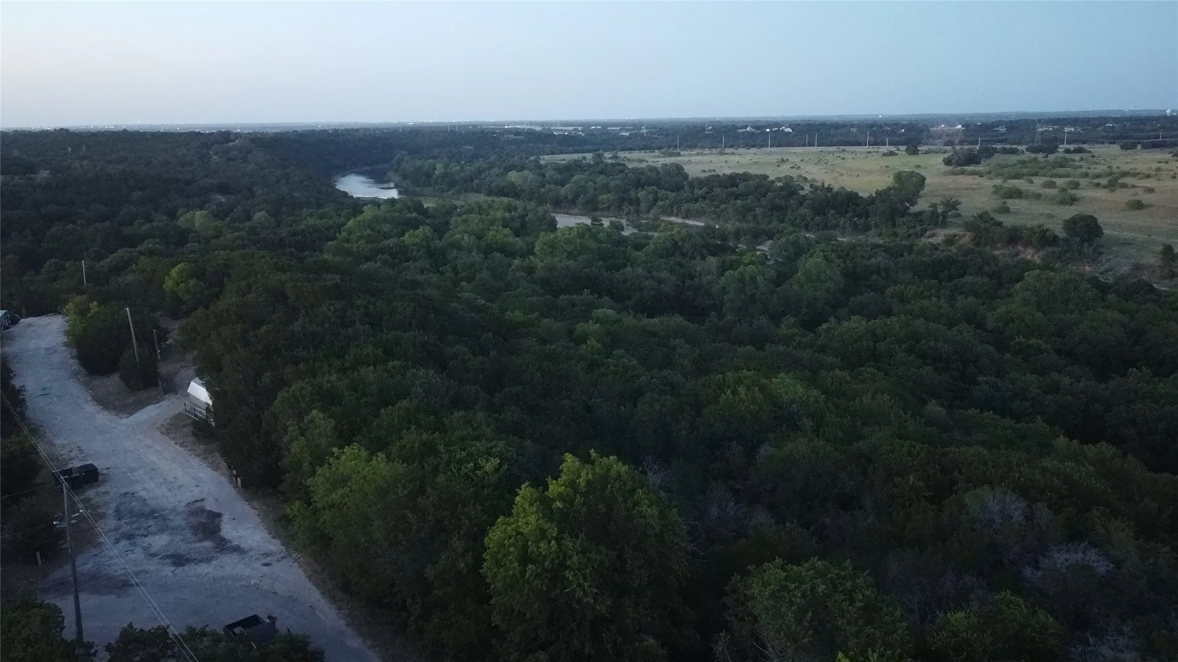 Expansive wooded acreage with a natural water feature