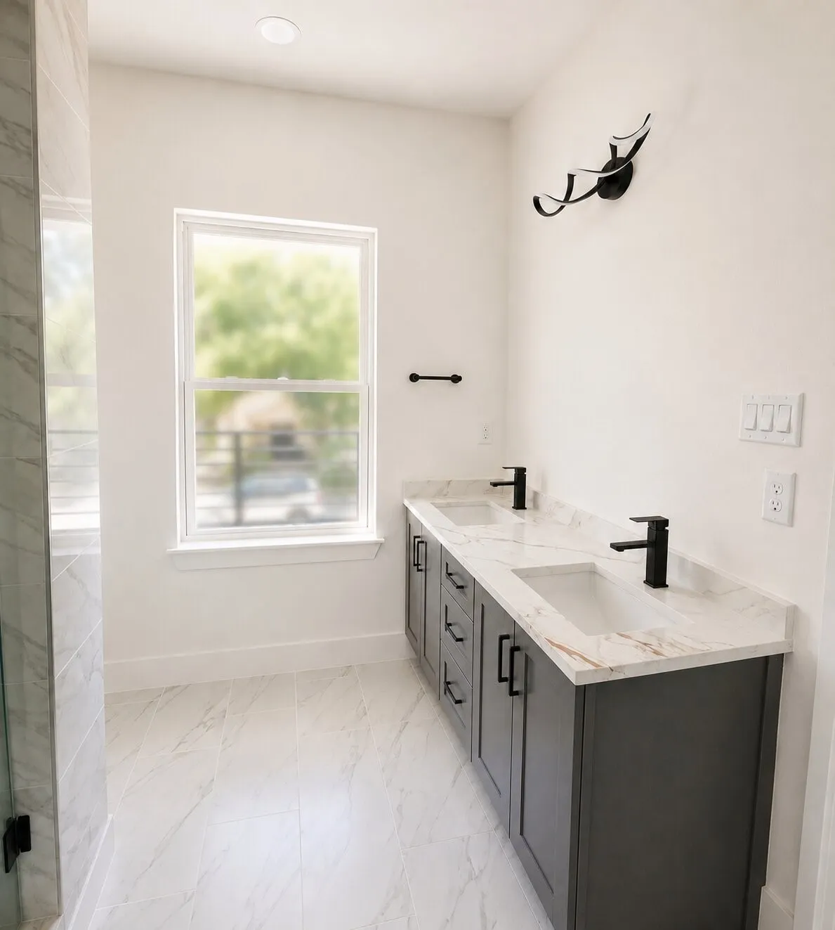 Dual vanity with integrated sinks, matte black faucets, and dark wood-finish cabinetry