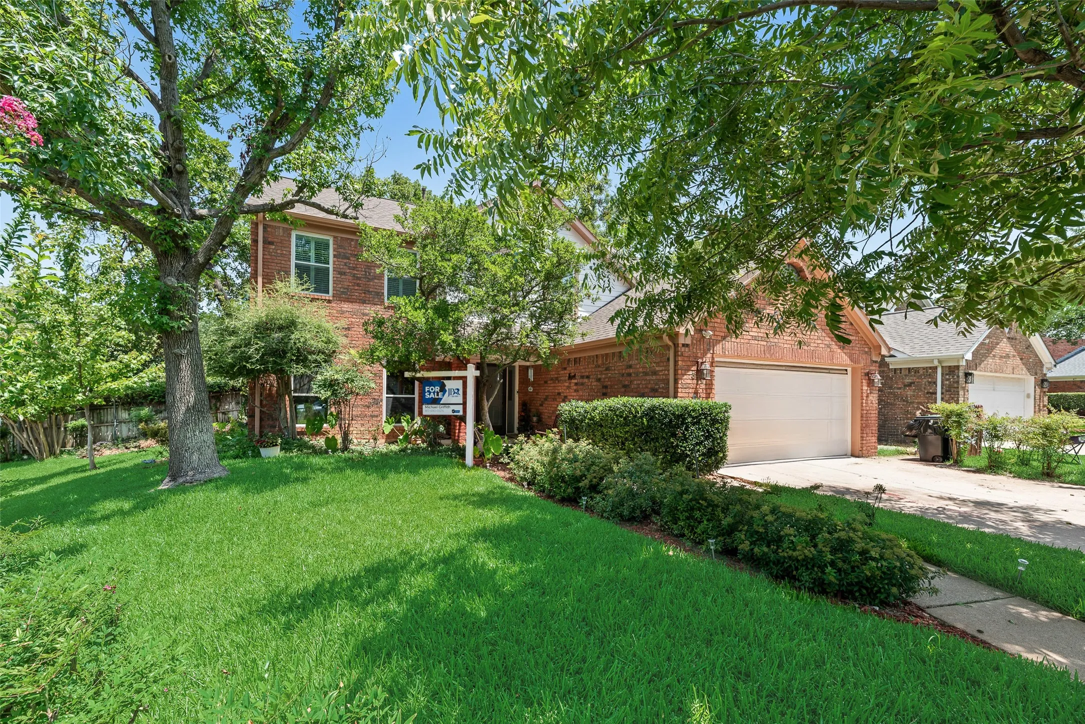 Brick exterior with a gabled roof and attached two-car garage