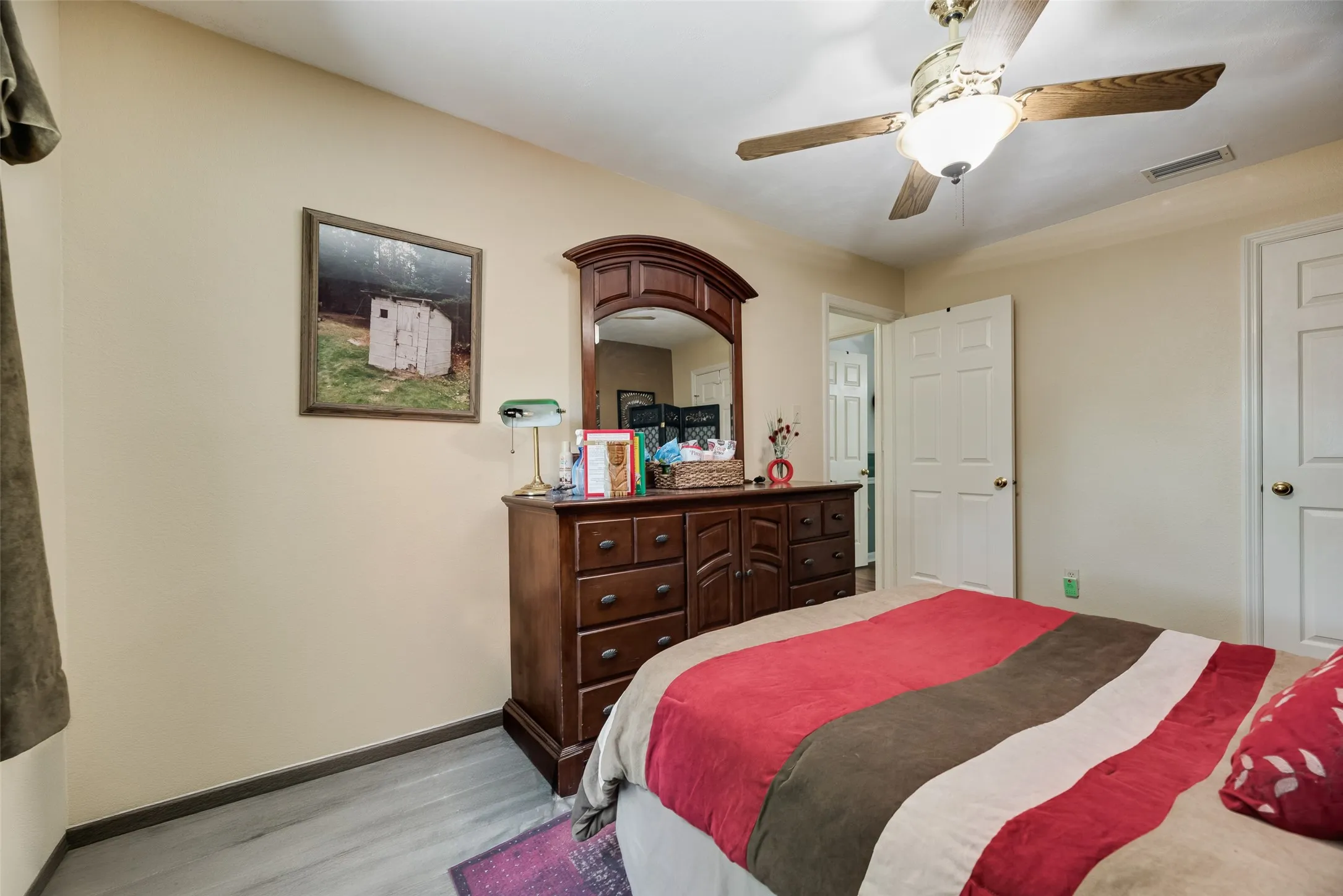 Wood-finish flooring with a ceiling fan light fixture