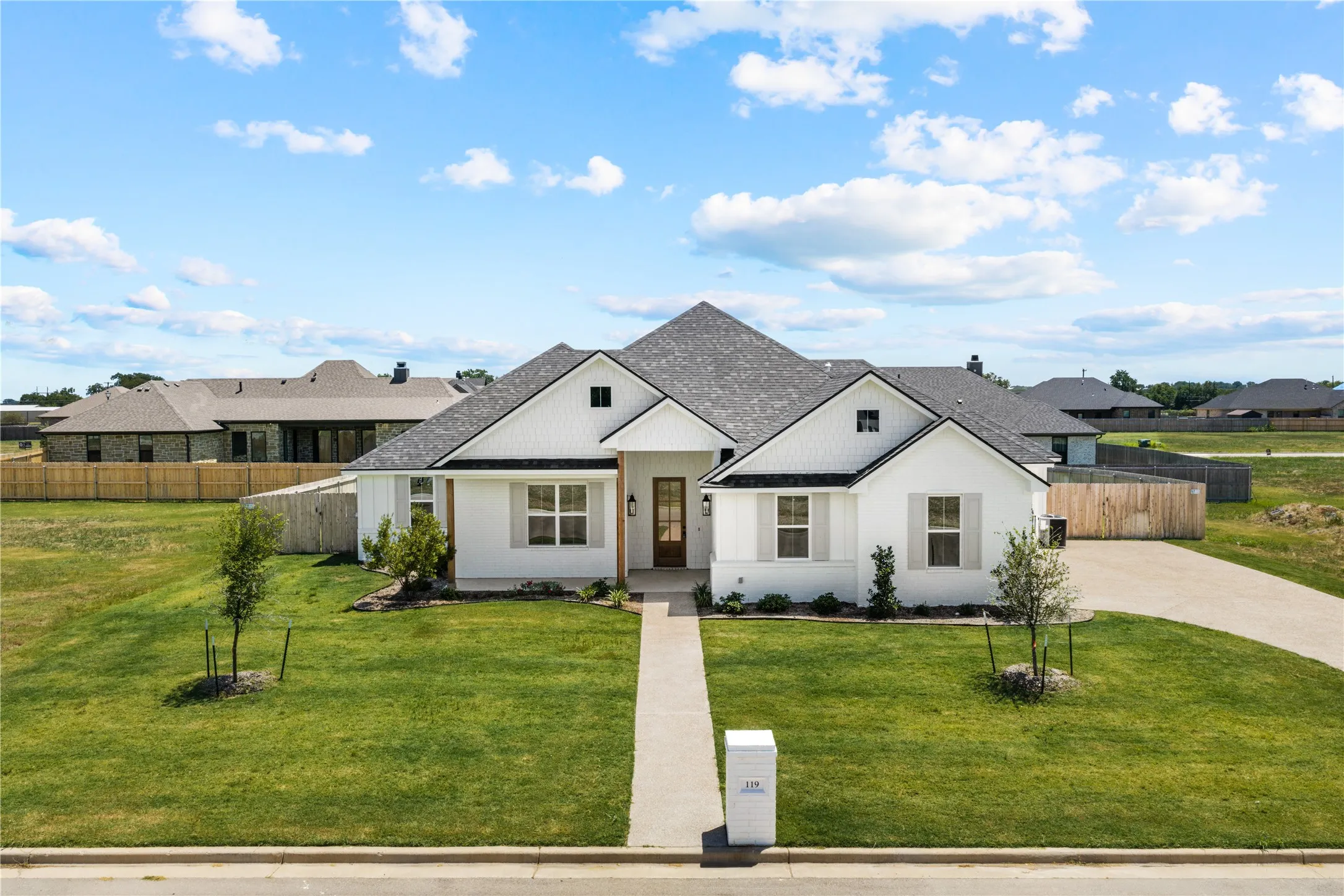 White exterior with black roof shingles