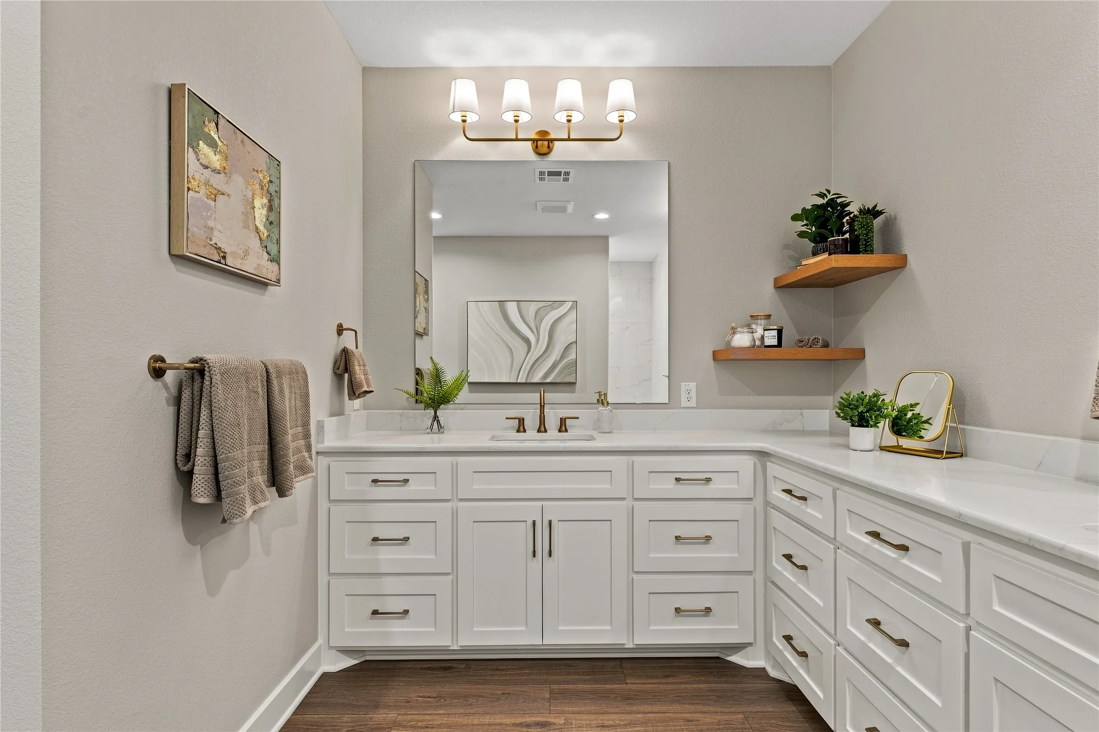 Expansive vanity with white cabinetry, integrated sink, and substantial countertop space