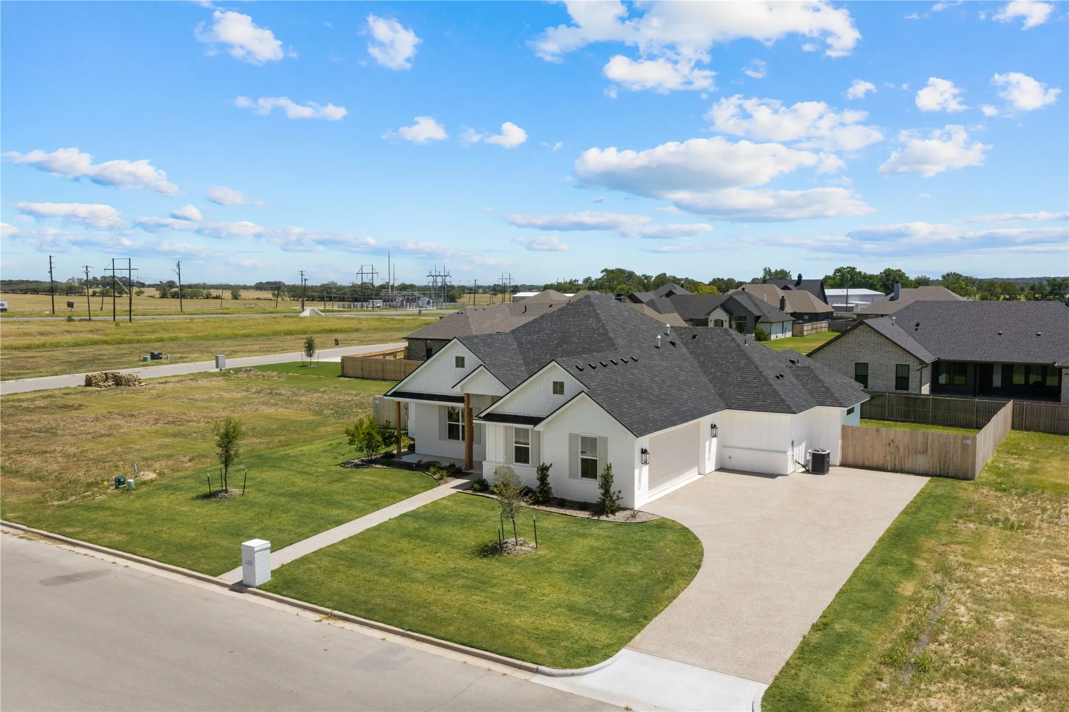 Single-story residence featuring a dark shingle roof and a two-car garage
