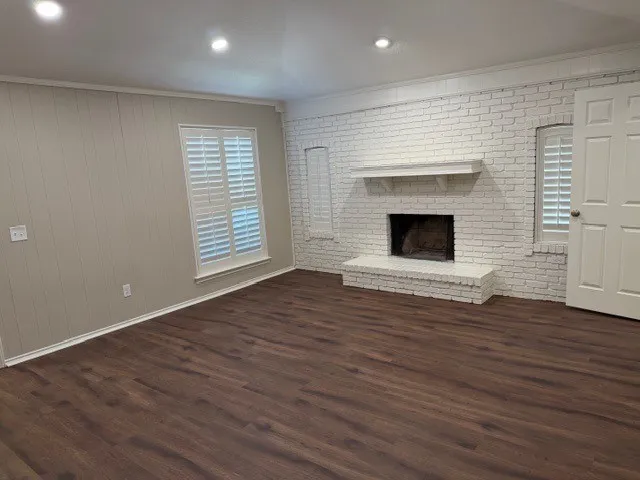 Brick fireplace with white painted finish and mantel
