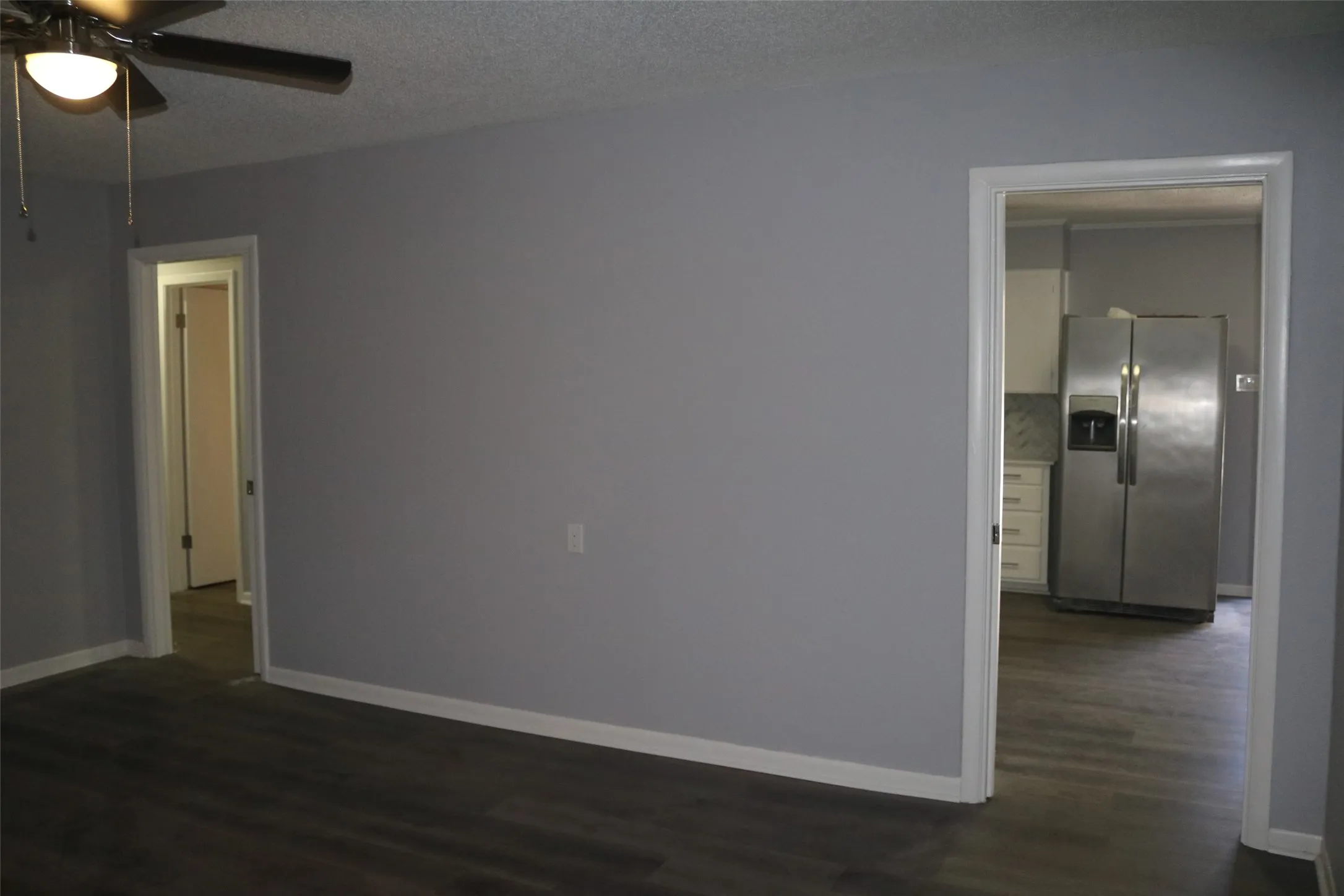 Wood-finish flooring with a ceiling fan light fixture