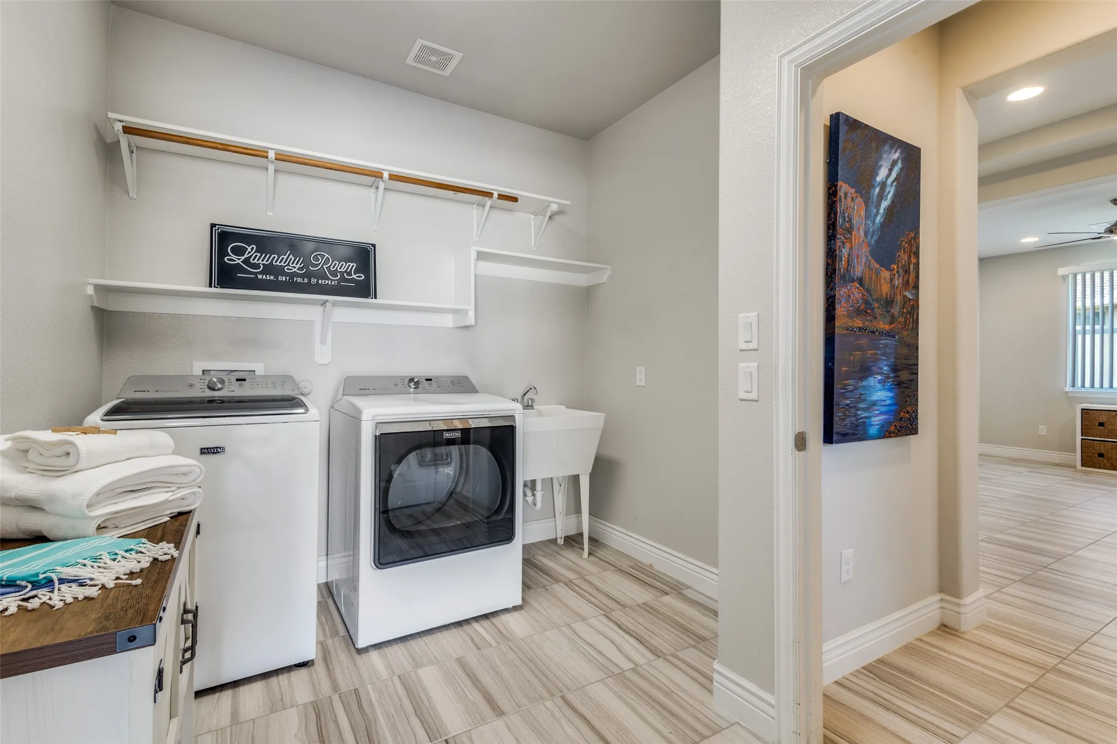 JUST OFF THE GARAGE ENTRY, A GREAT SIZE LAUNDRY COMPLETE WITH WASHER DRYER. DEEP BASIN SINK FOR THOSE SPECIAL CLEAN UPS AND ROOM FOR ADDITIONAL REFRIGERTOR.