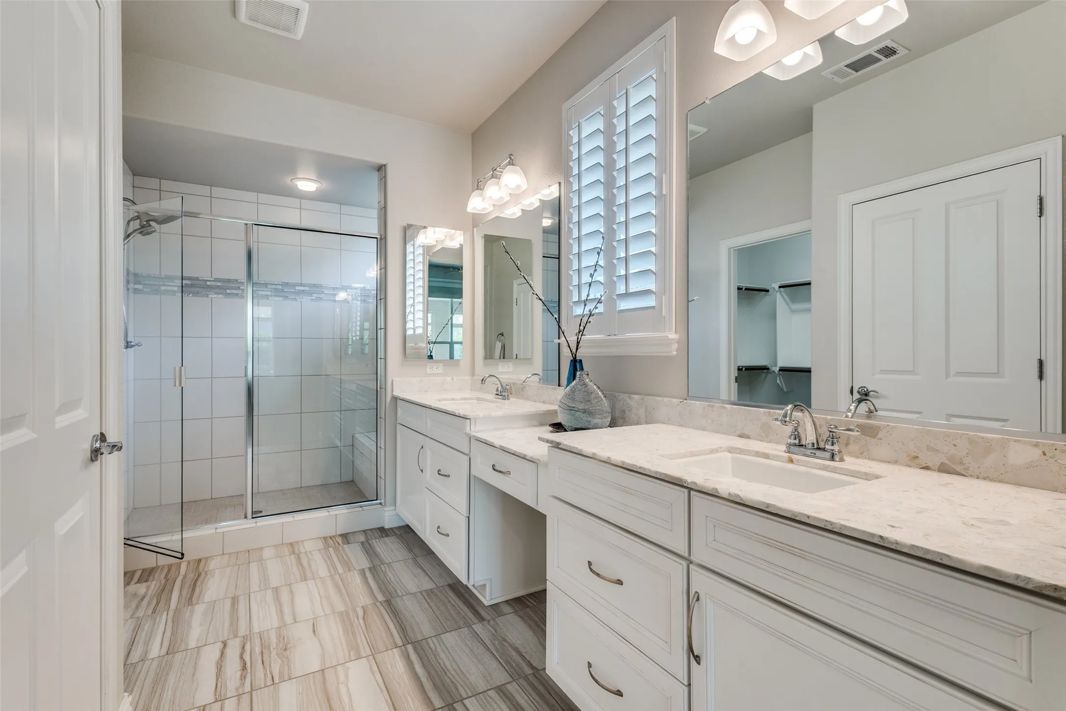THIS ENSUITE HAS A FULL SHOWER, DUAL SINK VANITY WITH SEATED VANITY SPACE. PLANTATION SHUTTER.