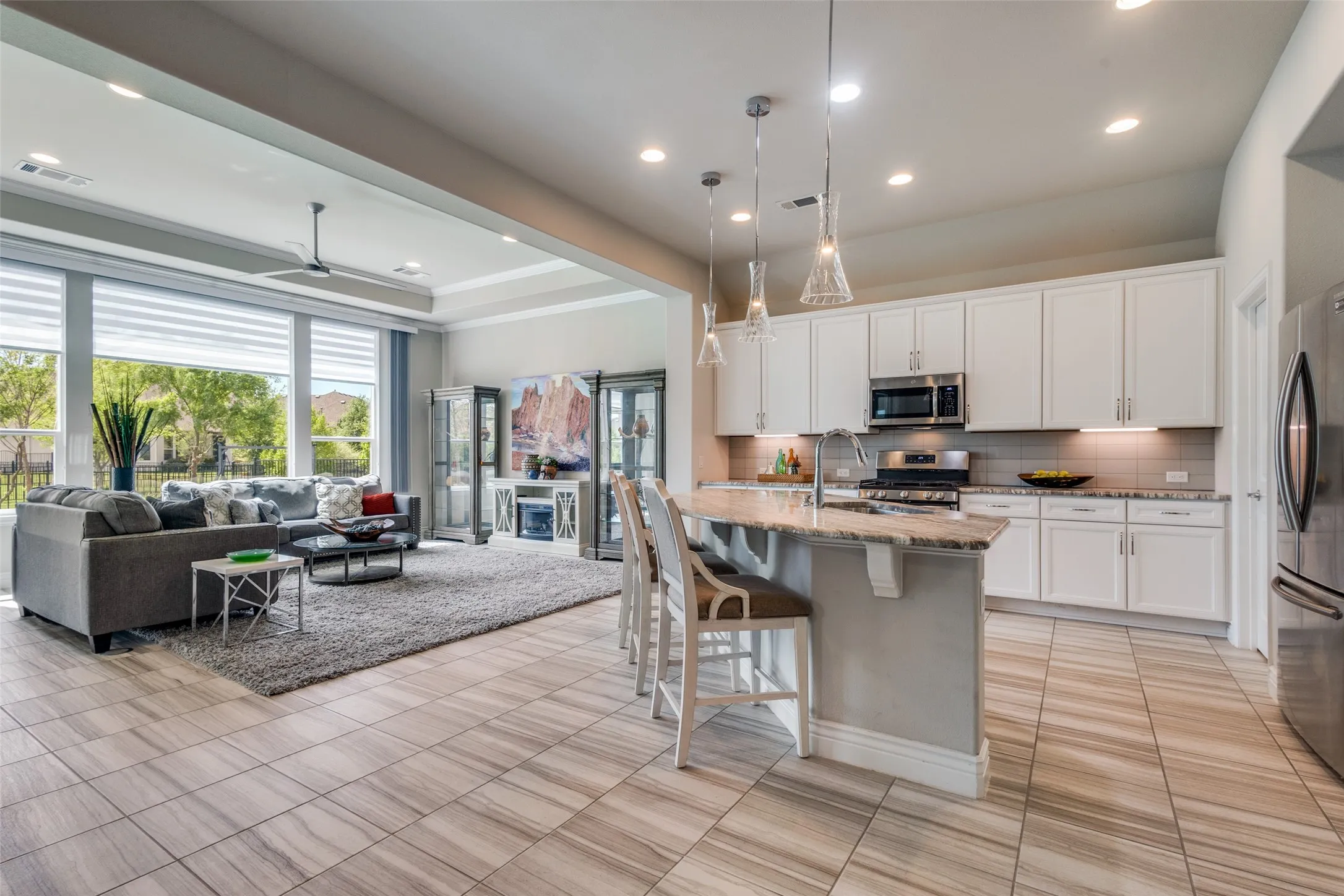 A KITCHEN THAT INVITES ENTERTAINMENT. ADORNED WITH STAINLESS APPLIANCES INCL GAS RANGE, SOFT CLOSE DRAWERS AND CABINETS, LIGHTING ABOVE AND BELOW AND XL ISLAND FOR ADDITIONAL DINING.