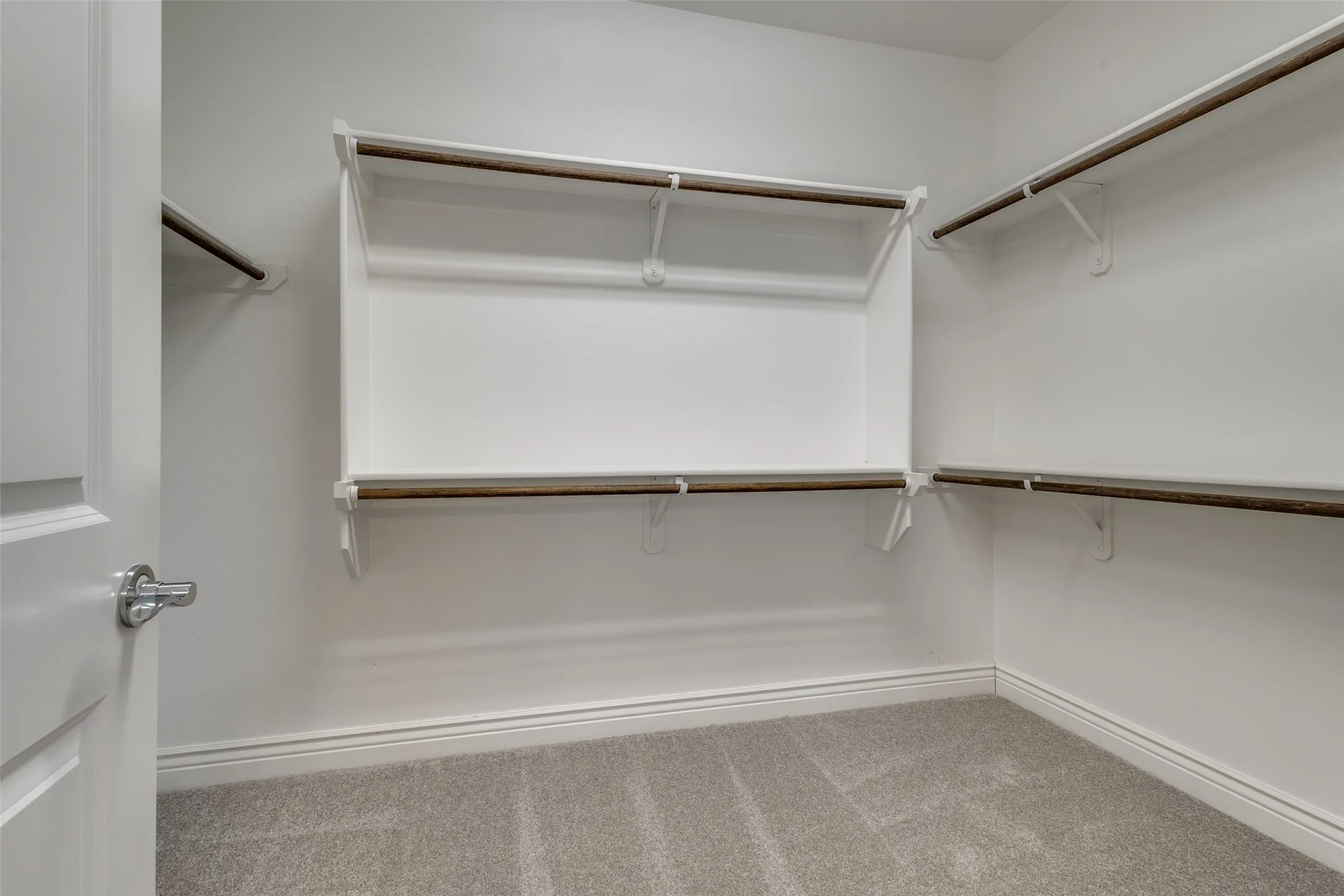 JUST A GLIMPSE OF THE PRIMARY CLOSET. WHAT YOU CANT SEE IS THE ADDITIONAL STORAGE SHELF. NEW CARPET TOO.