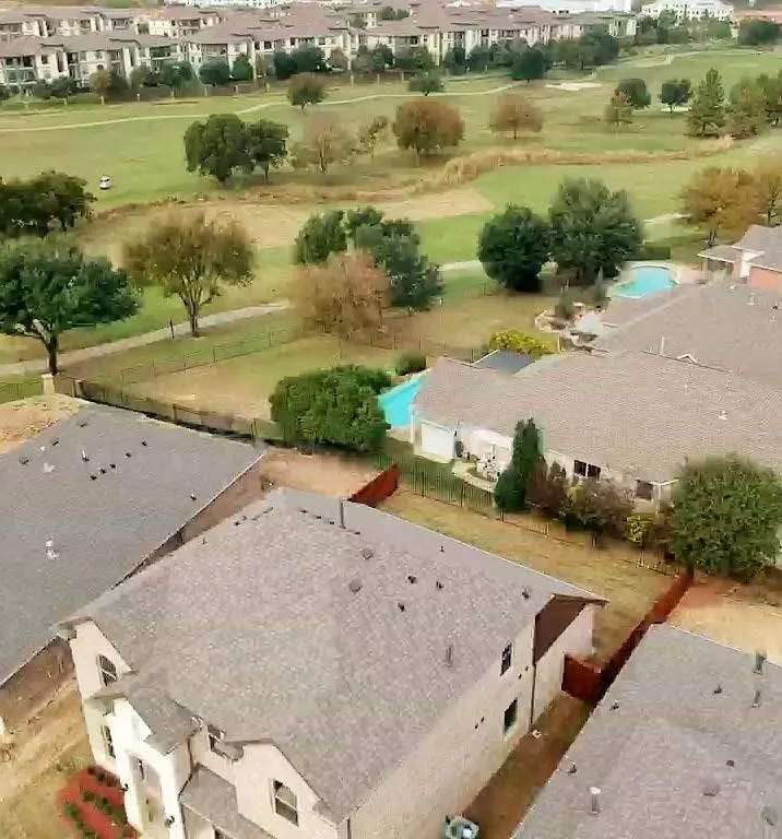 Aerial perspective showcasing a residential property with a shingle roof