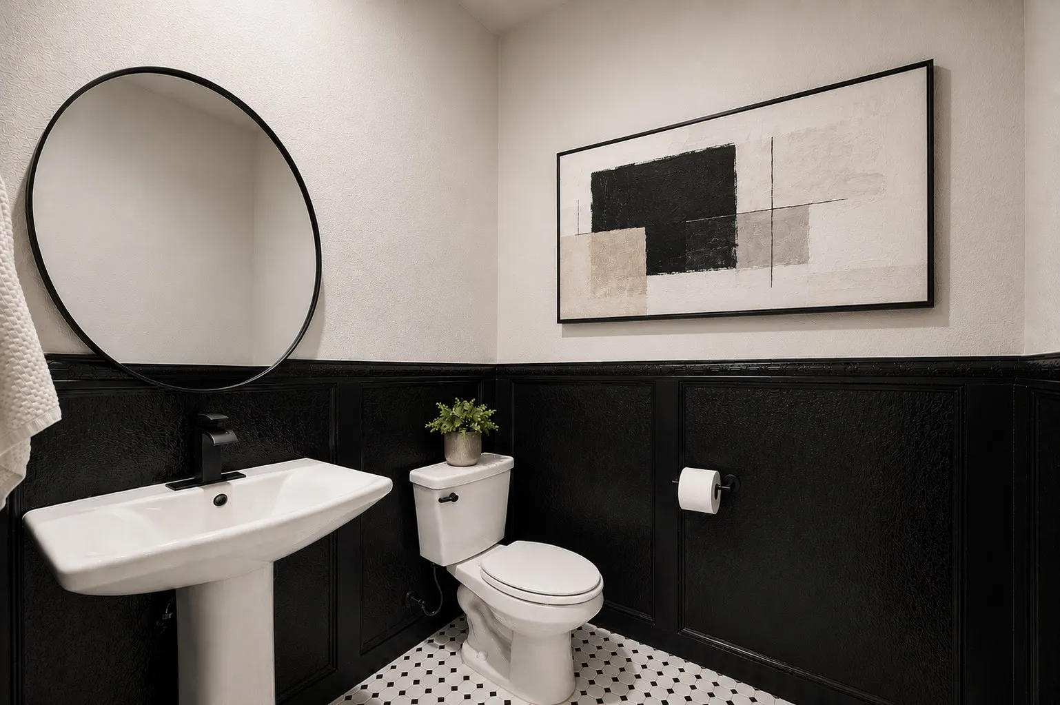 Pedestal sink with a matte black faucet, round wall-mounted mirror, black wainscoting, white and black mosaic tile flooring, and a standard toilet