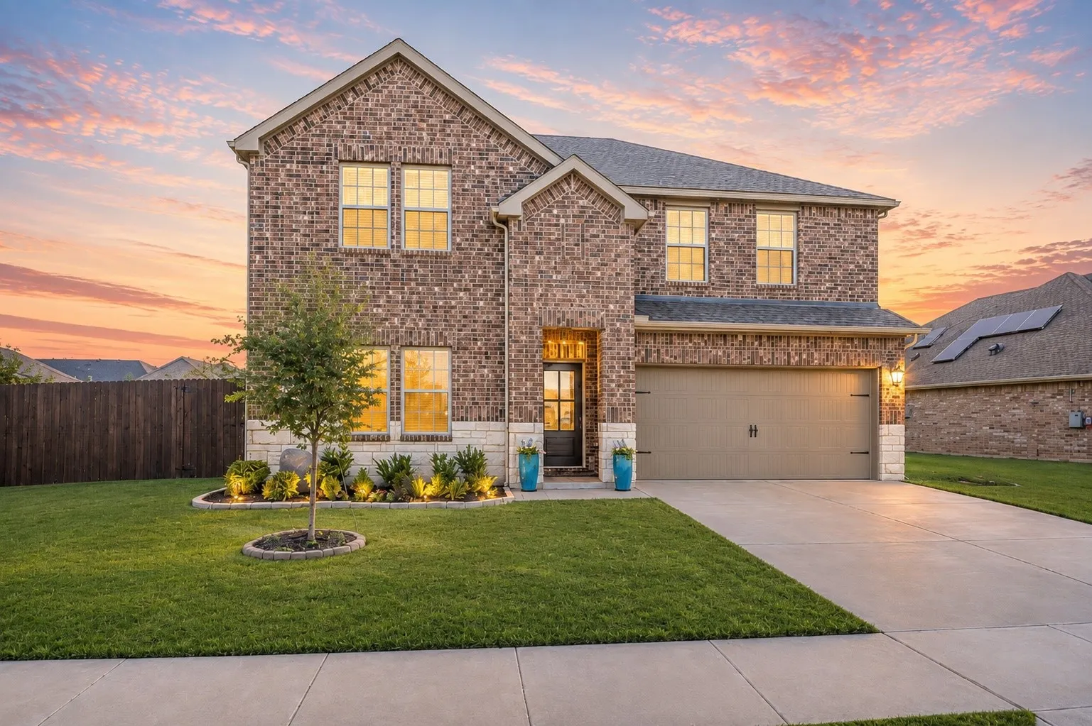 Brick and stone exterior with a prominent two-car garage