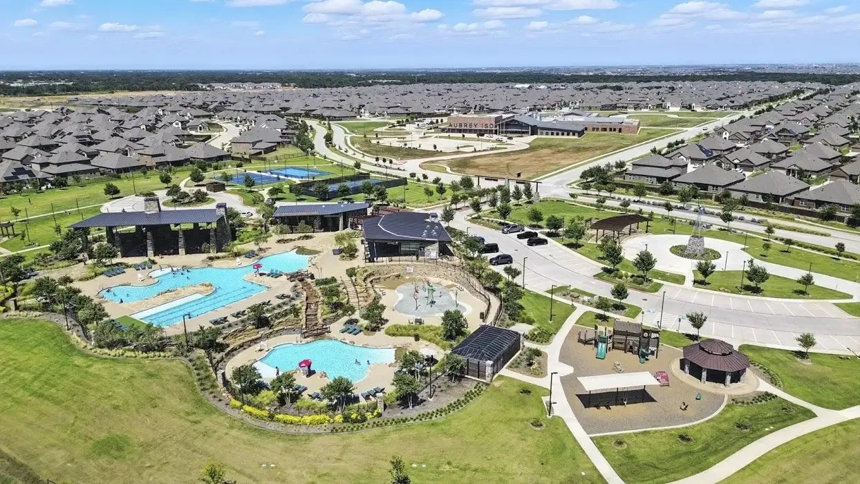 Expansive community amenities including multiple swimming pools, a dedicated splash pad, tennis courts, and a playground
