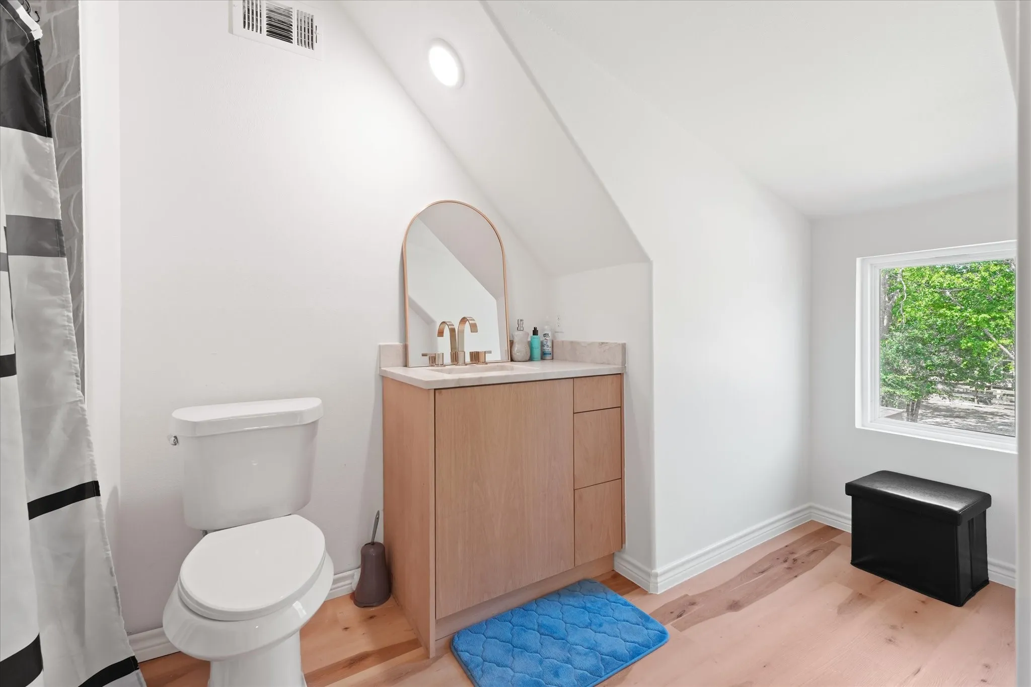 Modern vanity with a light wood-finish cabinet and countertop