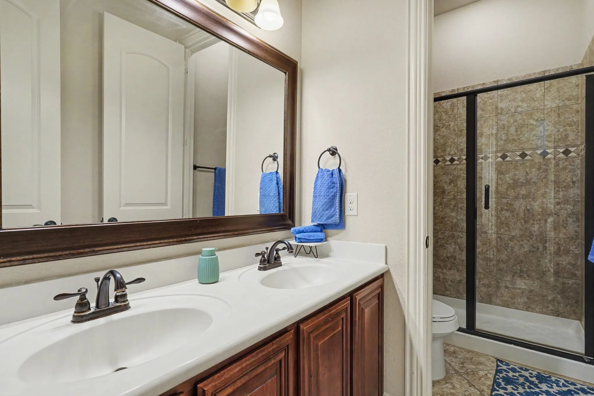 Dual vanity with white countertop and integrated sinks