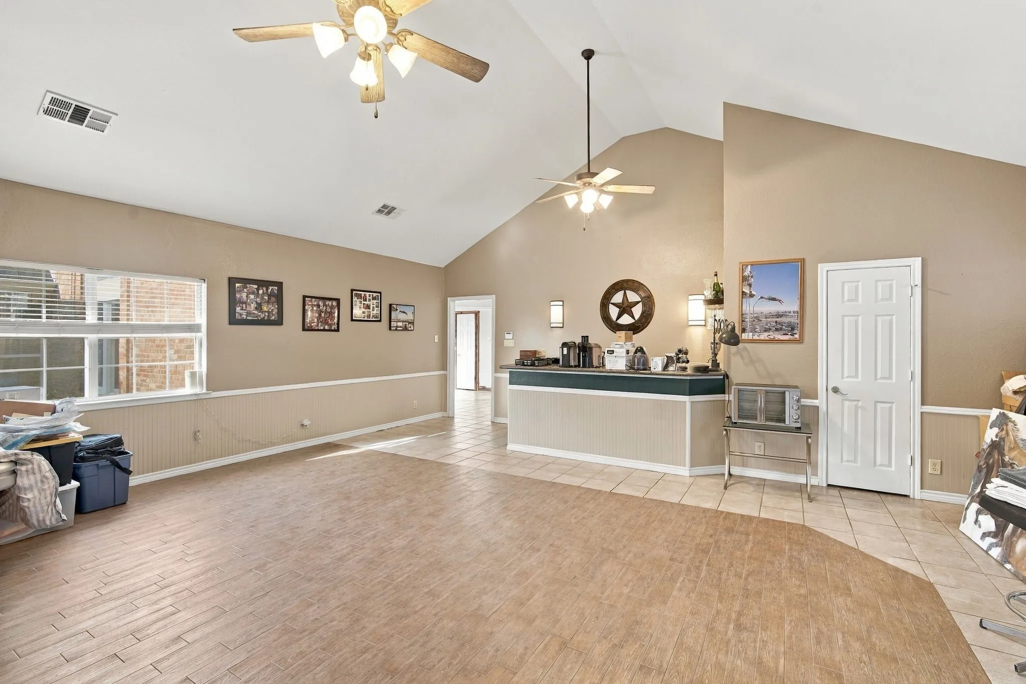 Huge room with ceiling fans, half bath and wet bar