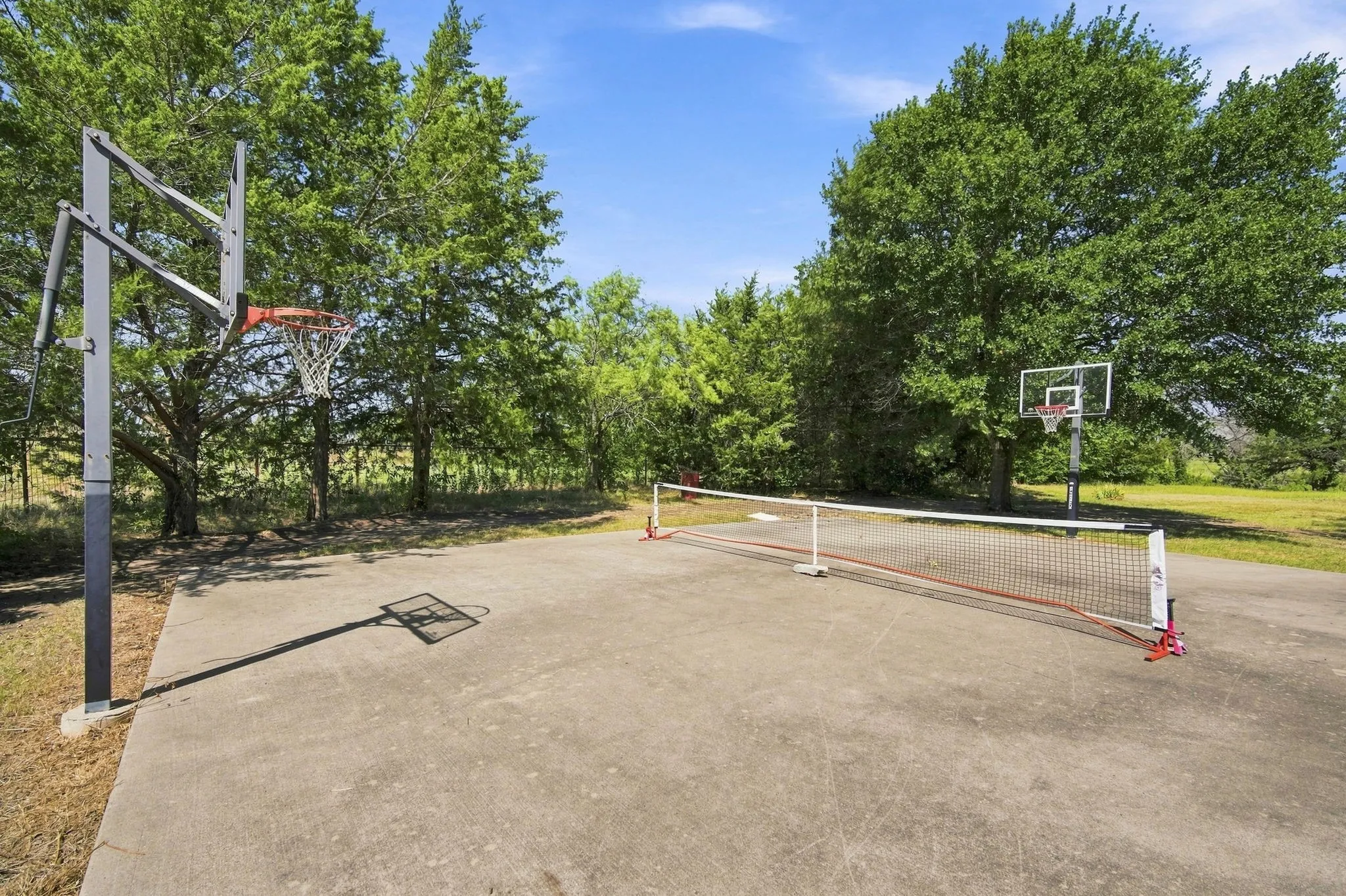 Cement slab with basketball / pickleball / racquetball possibilities (or possible building)