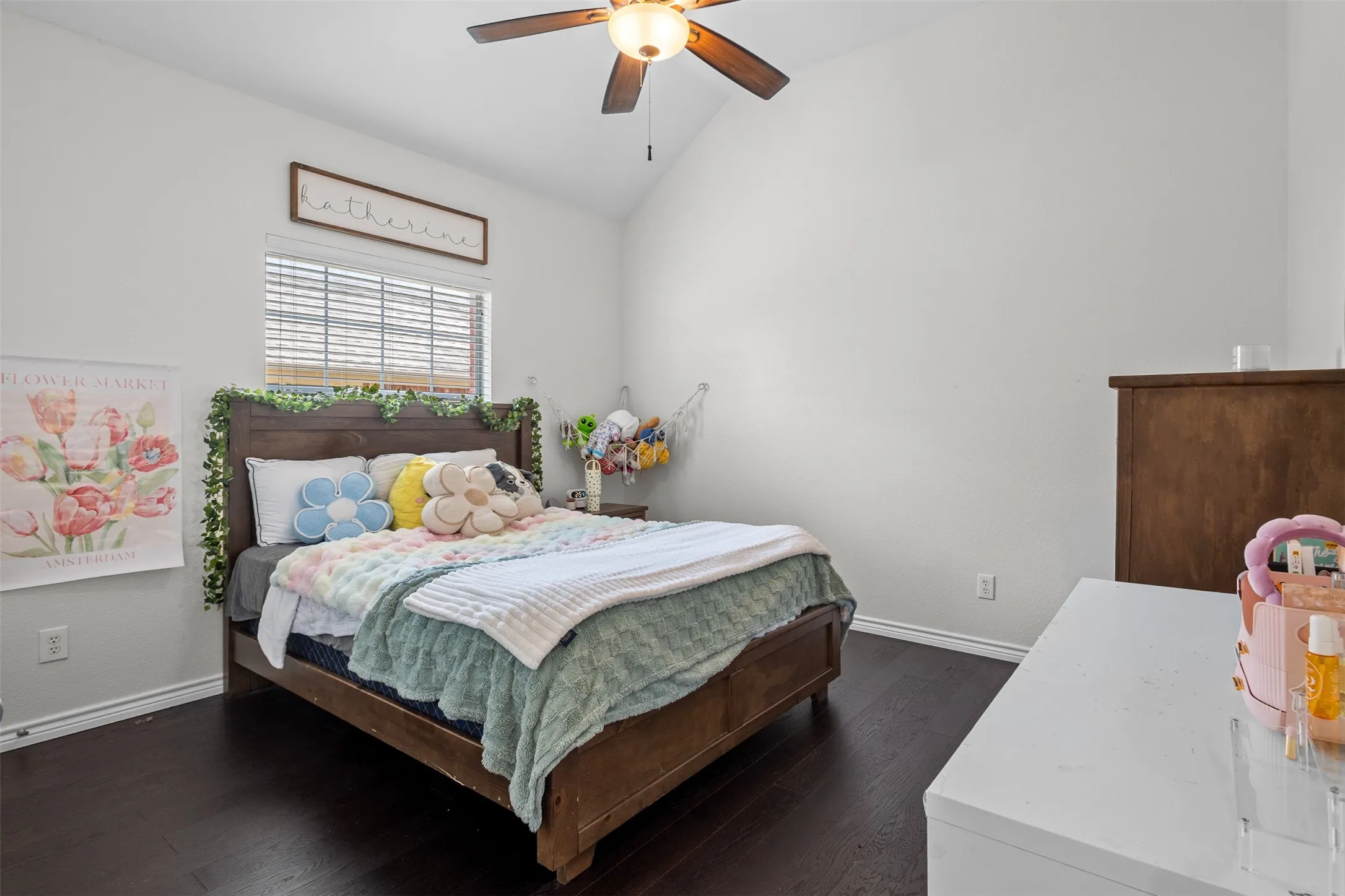 Vaulted ceiling with a ceiling fan, window with blinds, and dark wood-finish flooring