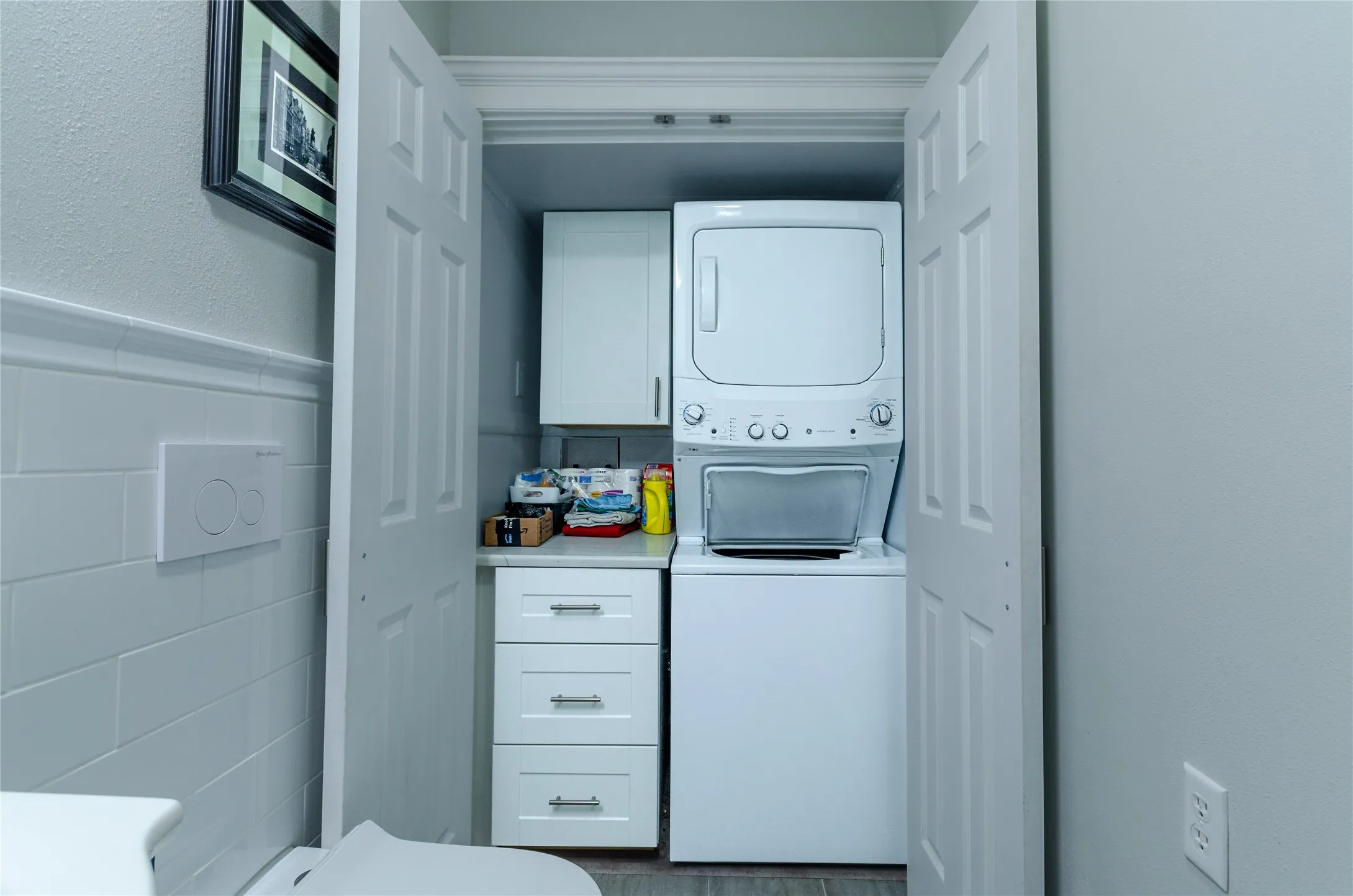 Built-in stacked laundry appliances within a dedicated closet