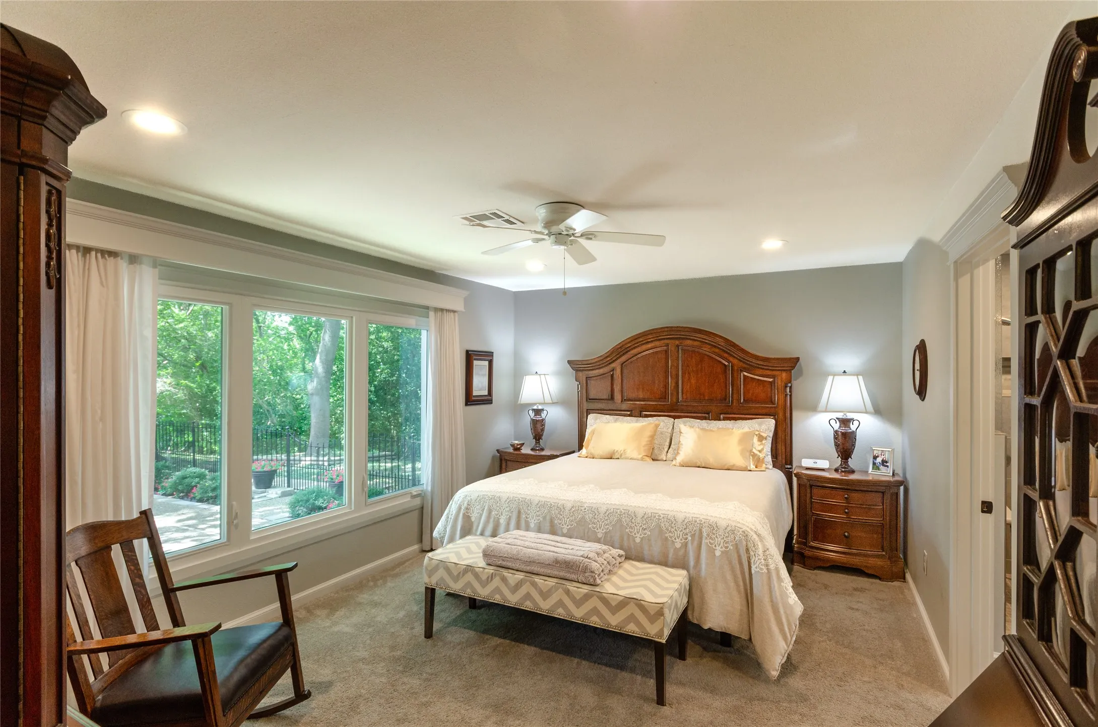 Recessed lighting with crown molding, ceiling fan, and large bay windows
