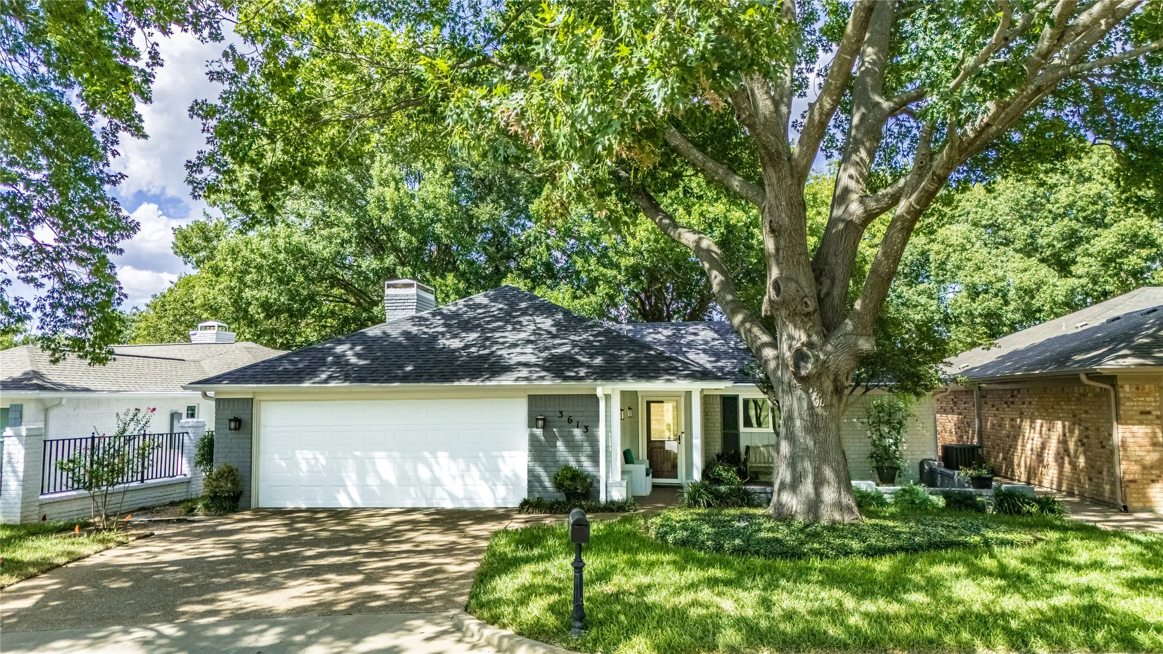 Contemporary exterior with a dark gray shingle roof, attached two-car garage, and a concrete driveway