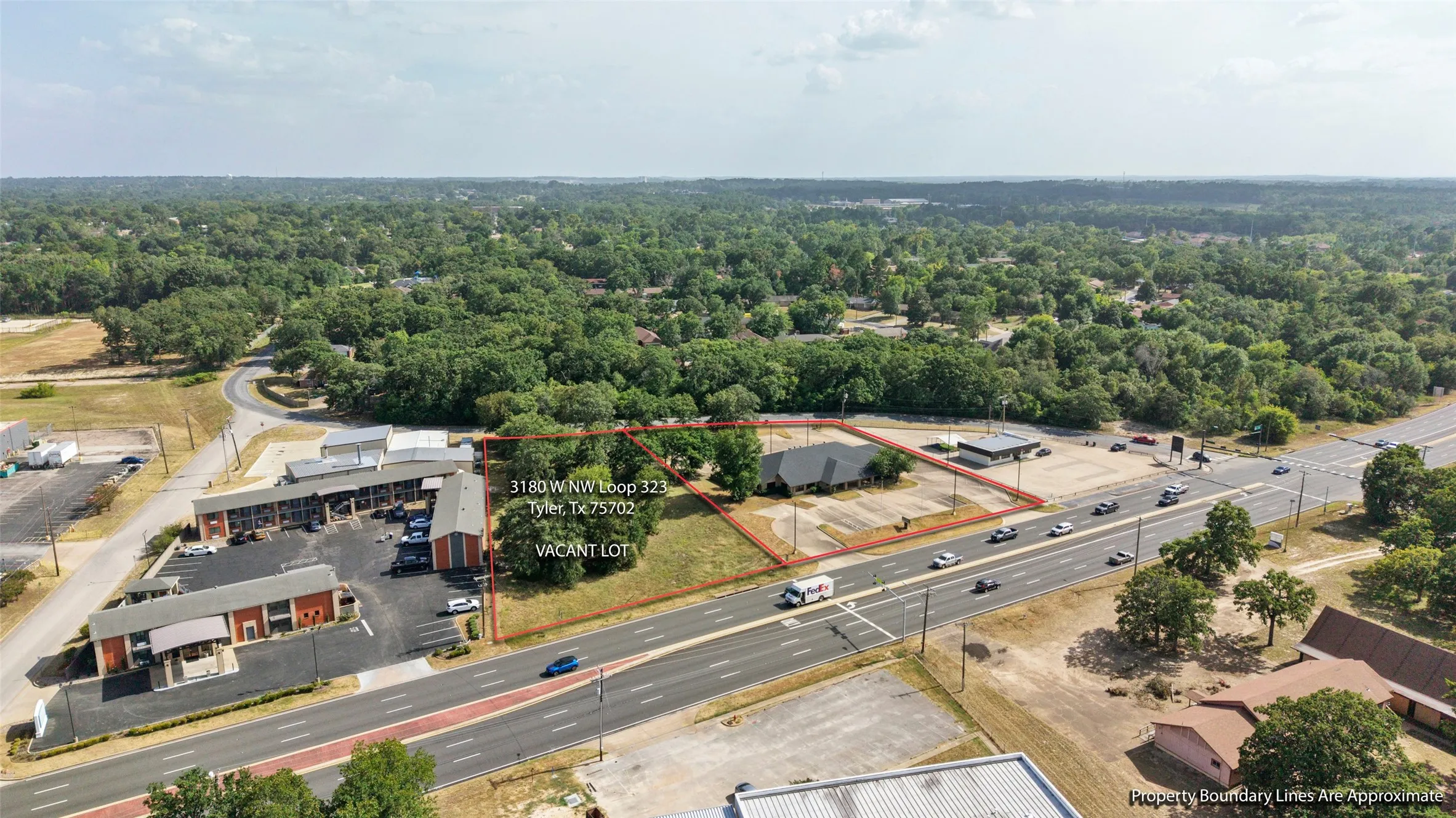 Expansive vacant lot featuring a paved parking area and direct road frontage.  Opportunity to expand! 3180 W NW LOOP 323 TYLER Adjacent 1.01-acre commercial lot available SEPARATELY for $110,000. Lot is NOT included in the building’s listed price.