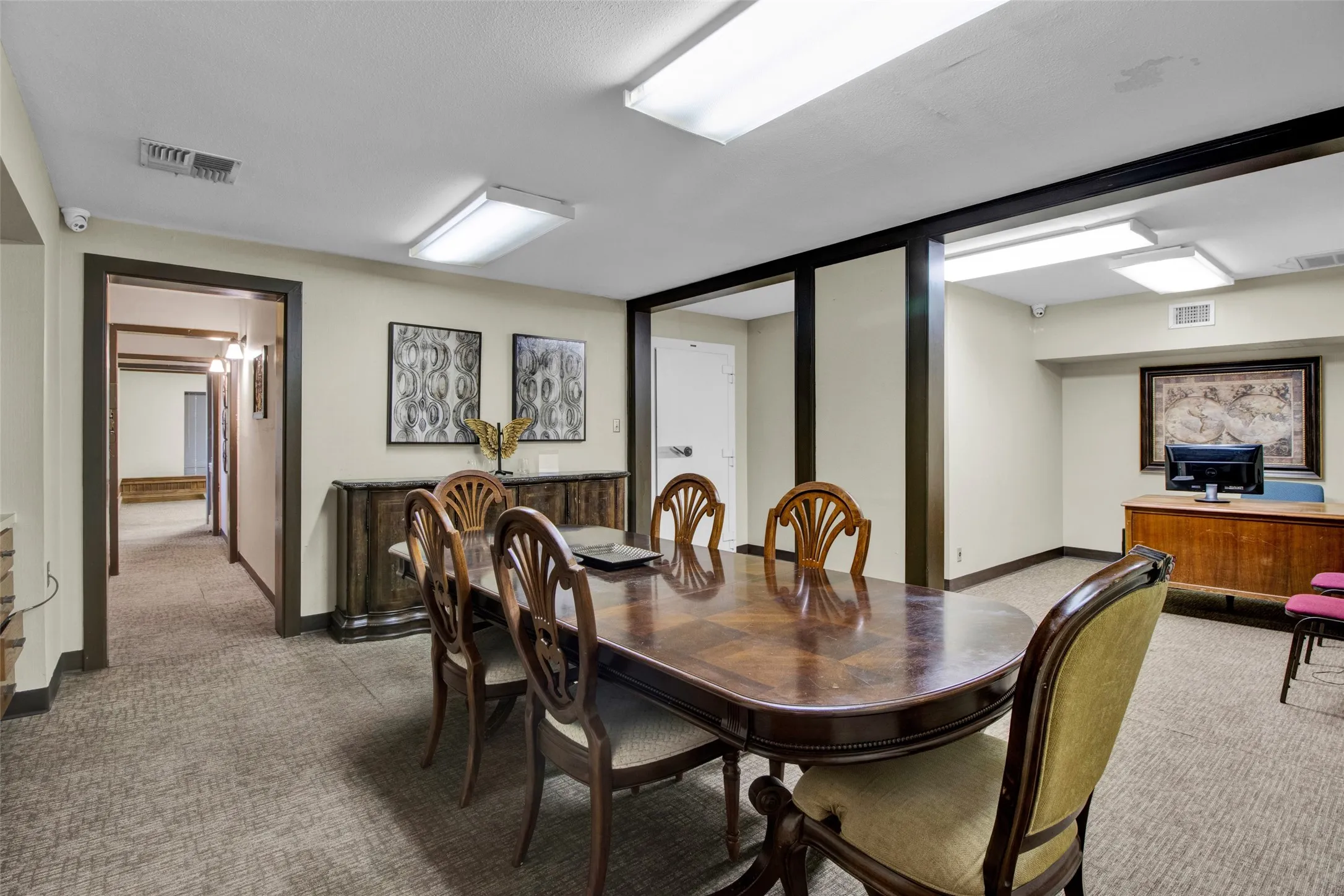 Carpeted flooring throughout, recessed lighting, and contrasting dark wood trim