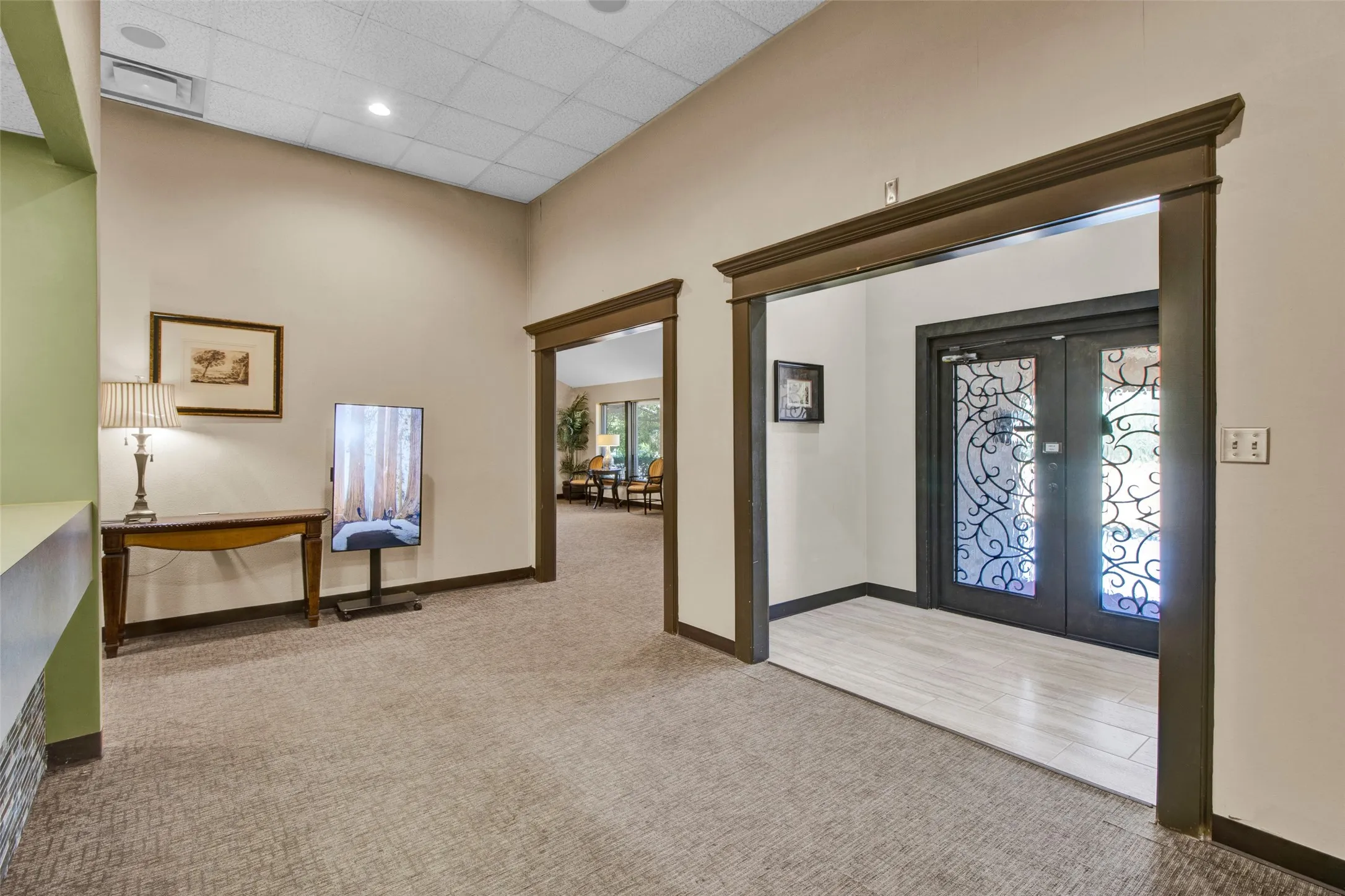Entryway featuring double doors with decorative glass panels, light wood-finish flooring, and recessed ceiling lighting