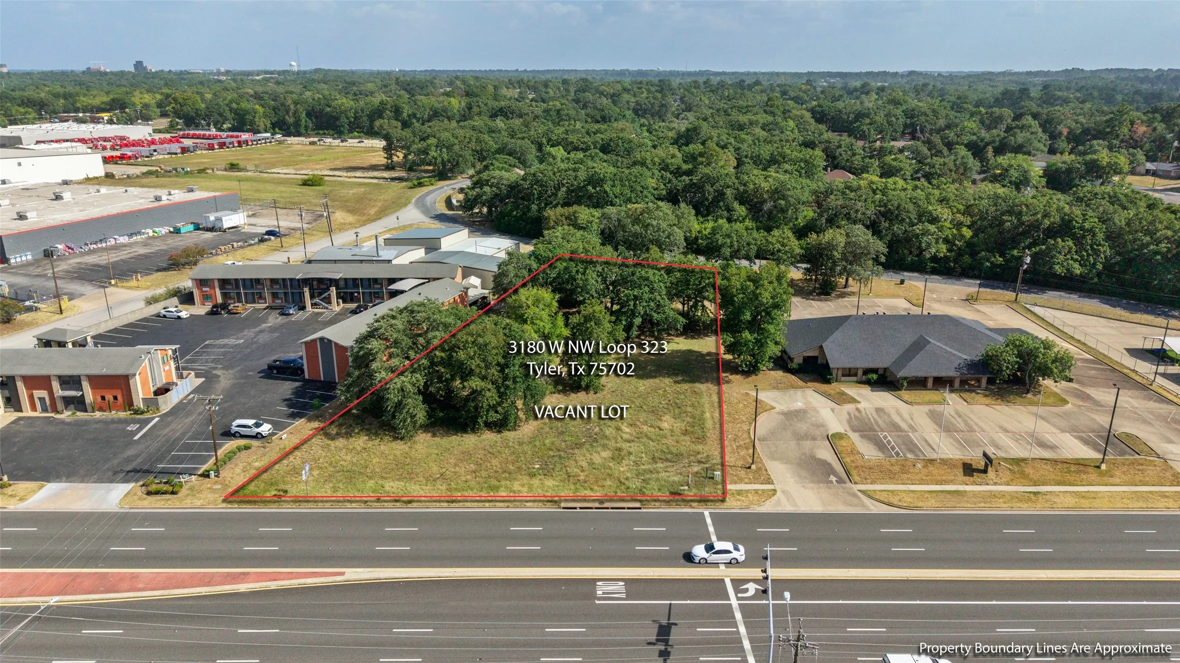 Vacant lot with mature trees Opportunity to expand! 3180 W NW LOOP 323 TYLER Adjacent 1.01-acre commercial lot available SEPARATELY for $110,000. Lot is NOT included in the building’s listed price.