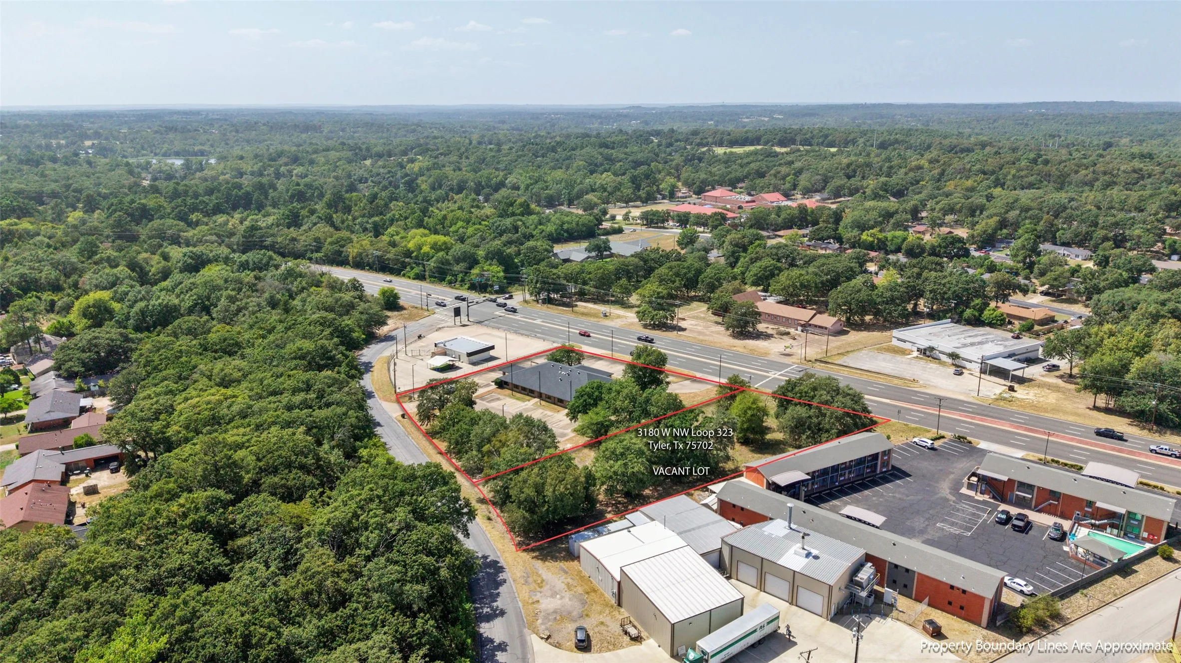 Vacant lot with significant road frontage, surrounded by mature trees Opportunity to expand! Adjacent 1.01-acre commercial lot available SEPARATELY for $110,000. Lot is NOT included in the building’s listed price.