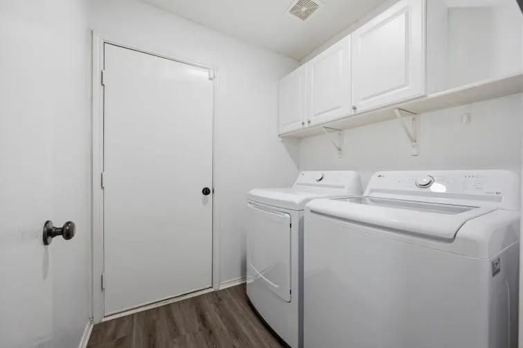 Dedicated laundry space with storage cabinets