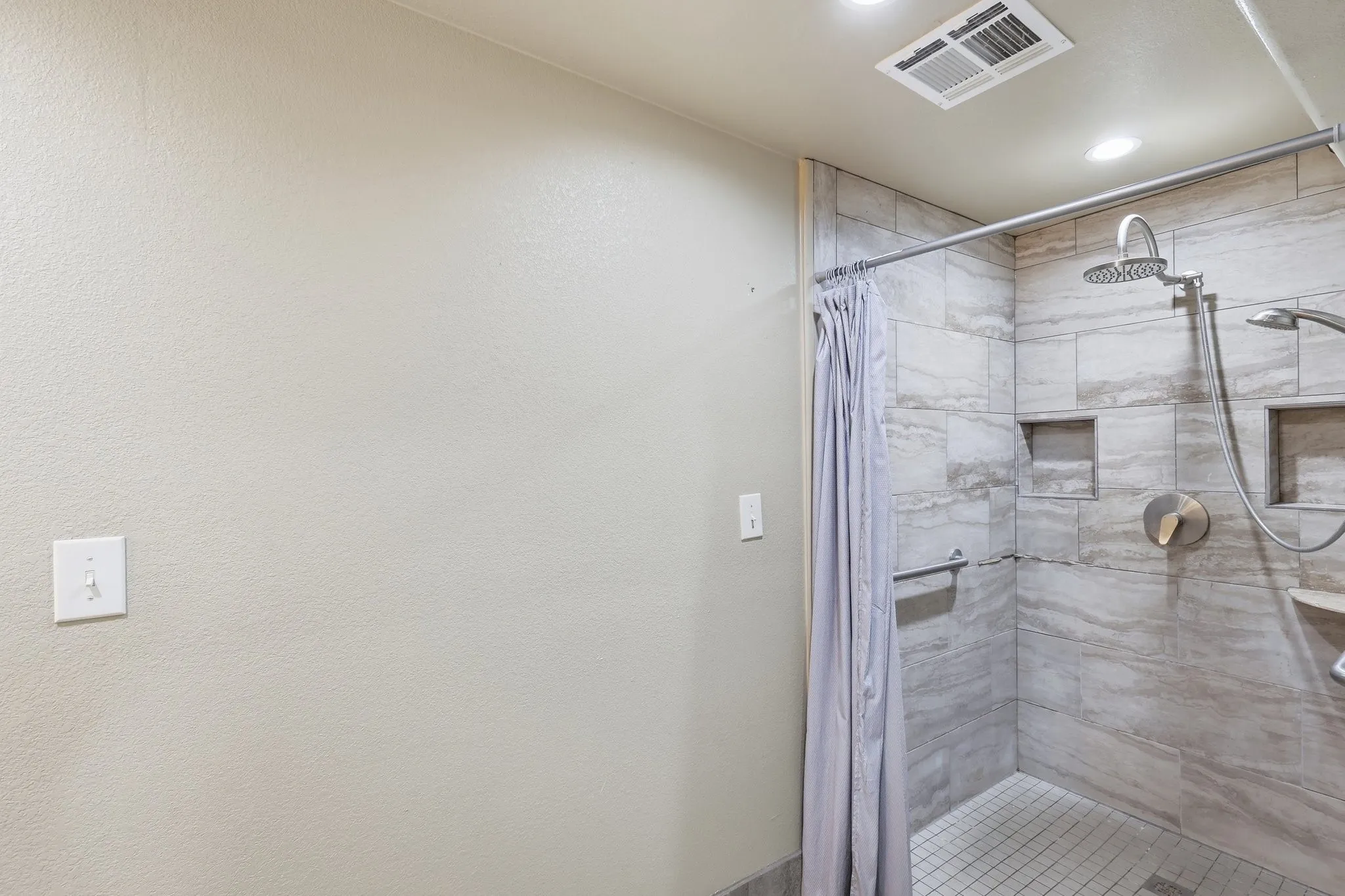 ADA shower with rails and lots of room to maneuver